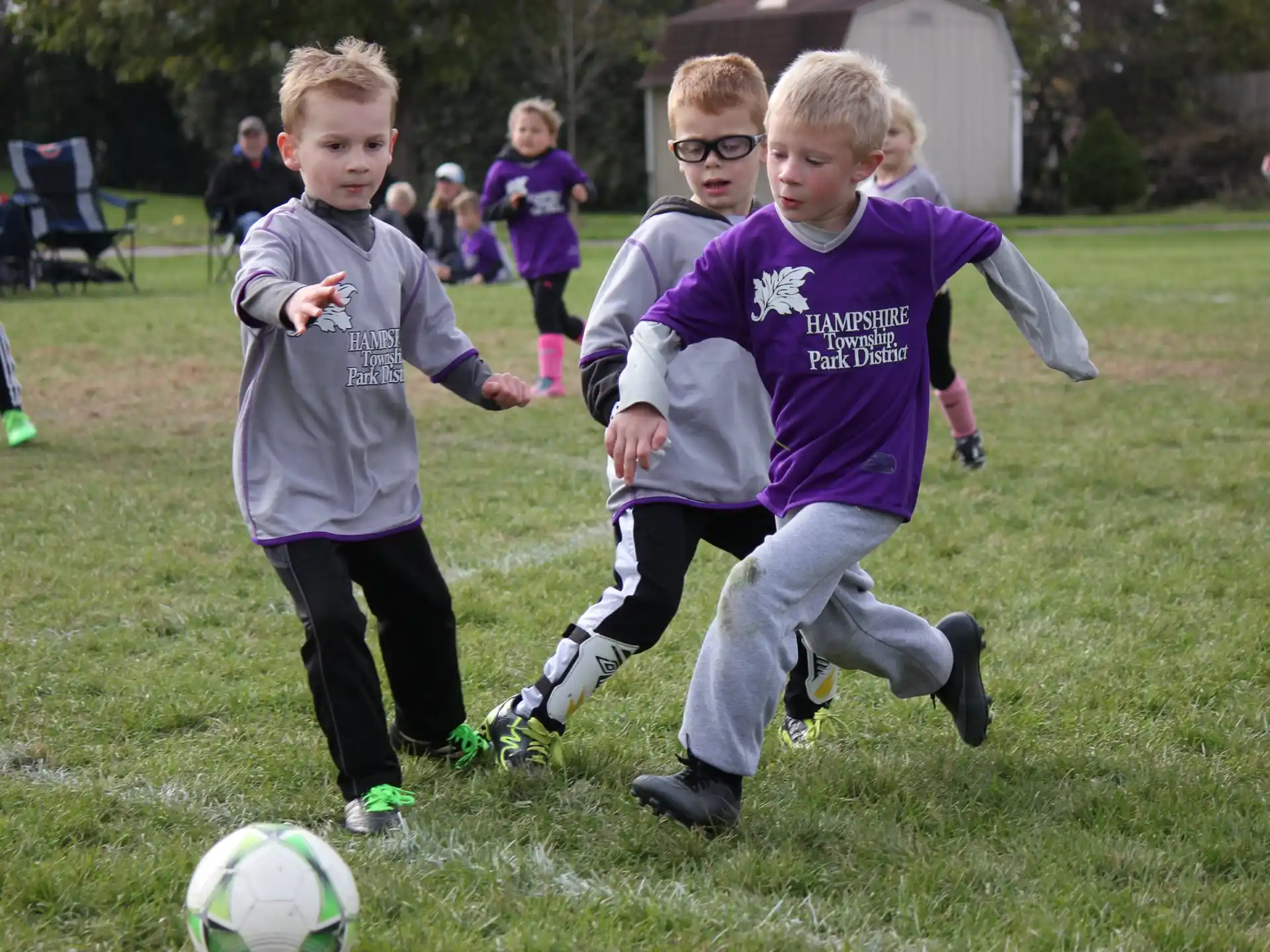kids chasing a football ball