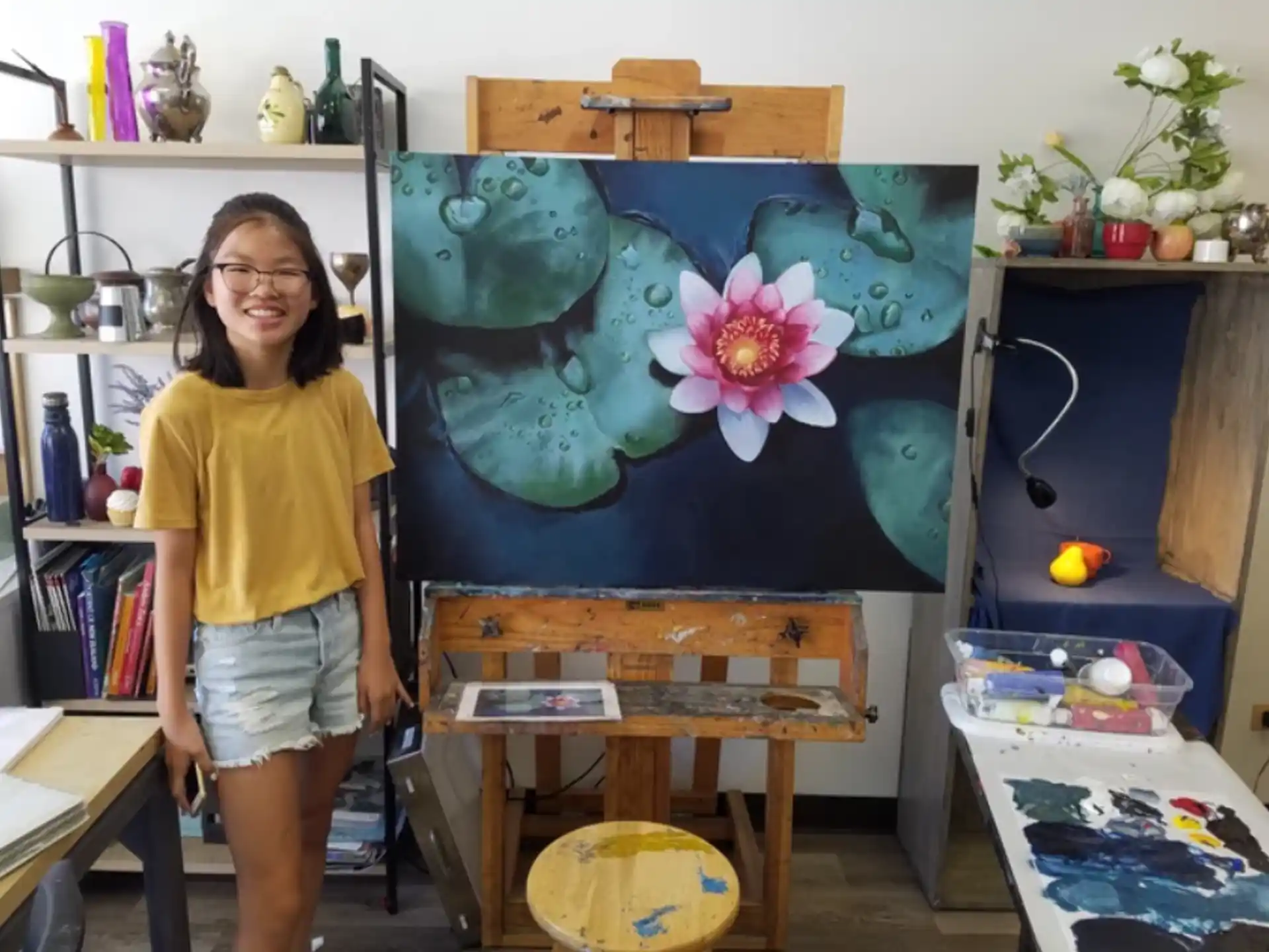 a person standing next to a painting