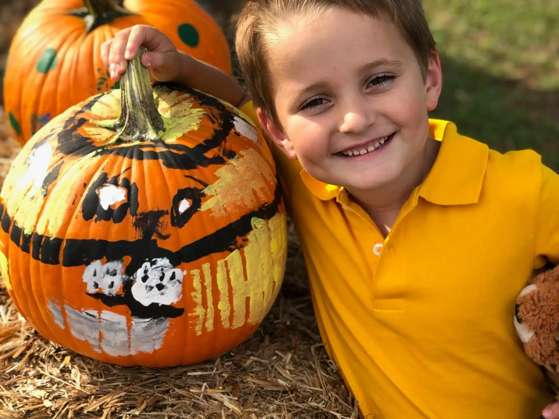 a boy holding a pumpkin