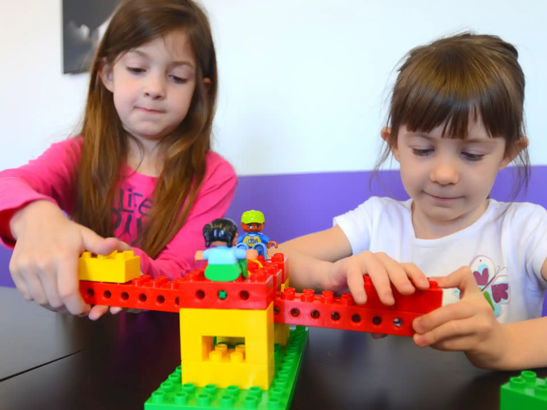 a couple of children playing with toys