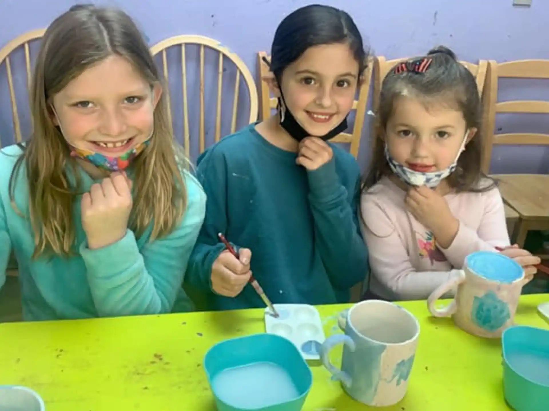 a group of girls sitting at a table