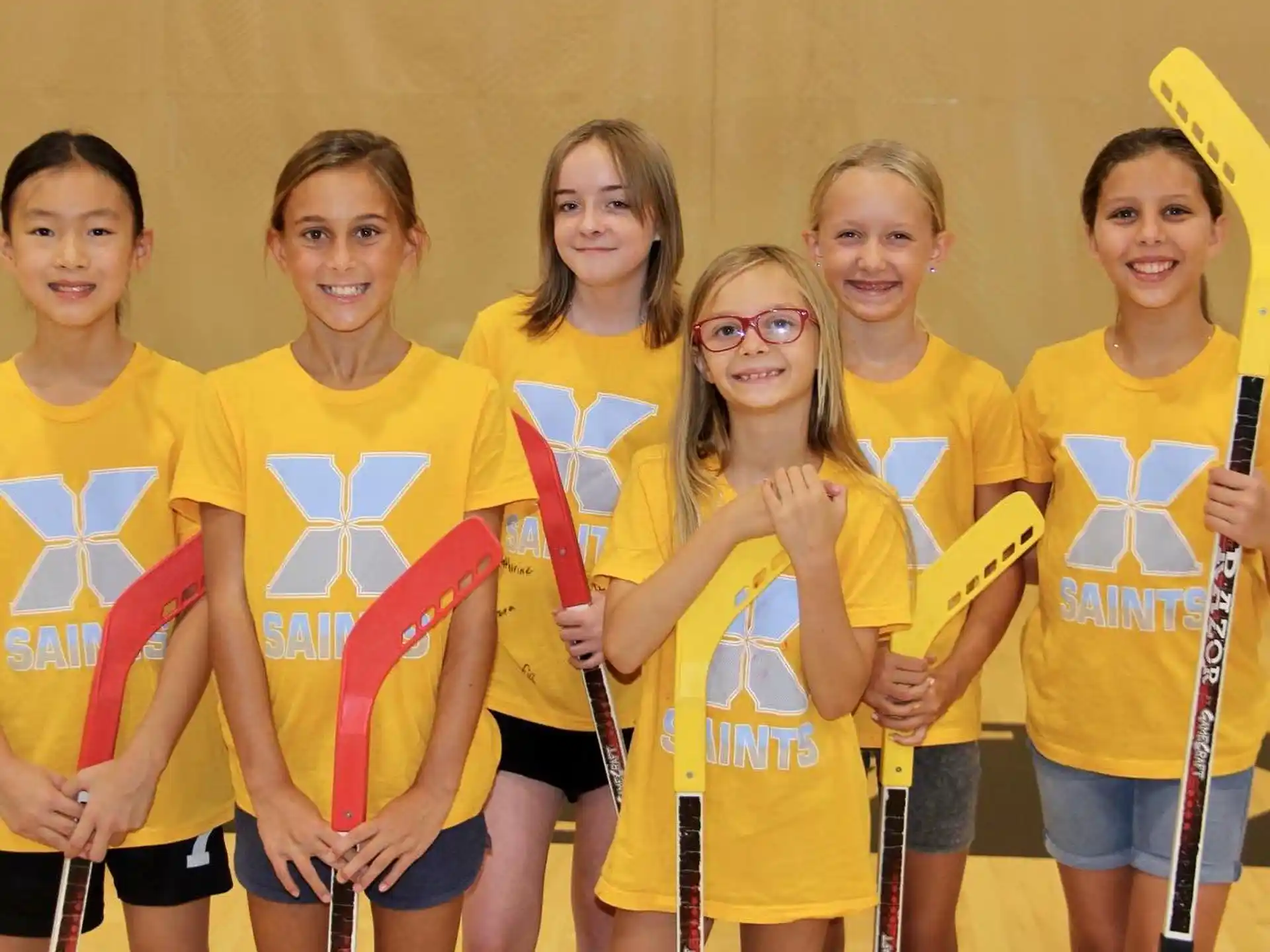 a group of girls wearing yellow shirts