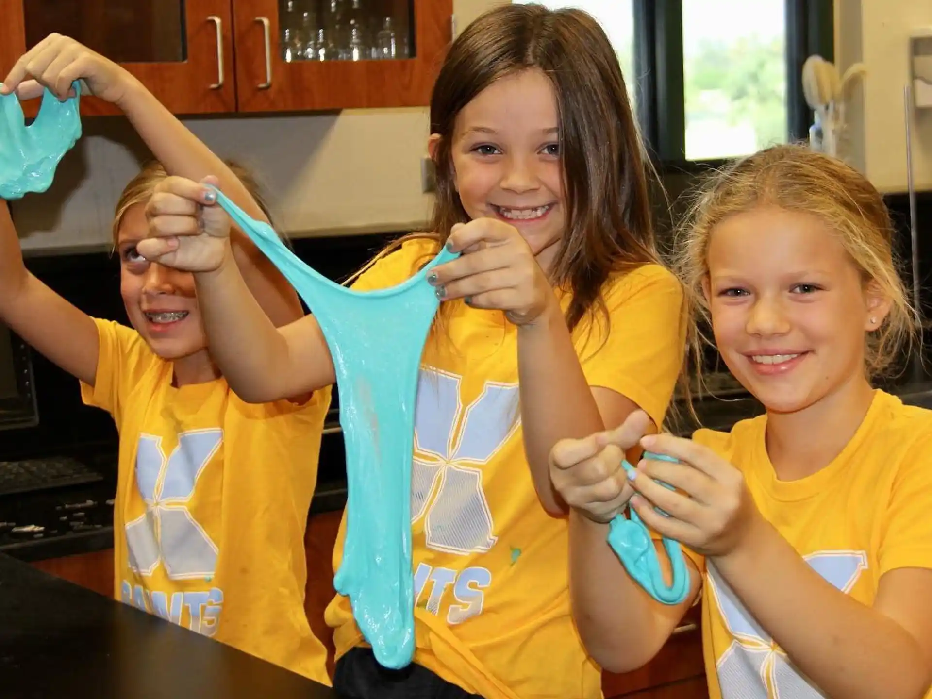 a group of kids holding toothbrushes
