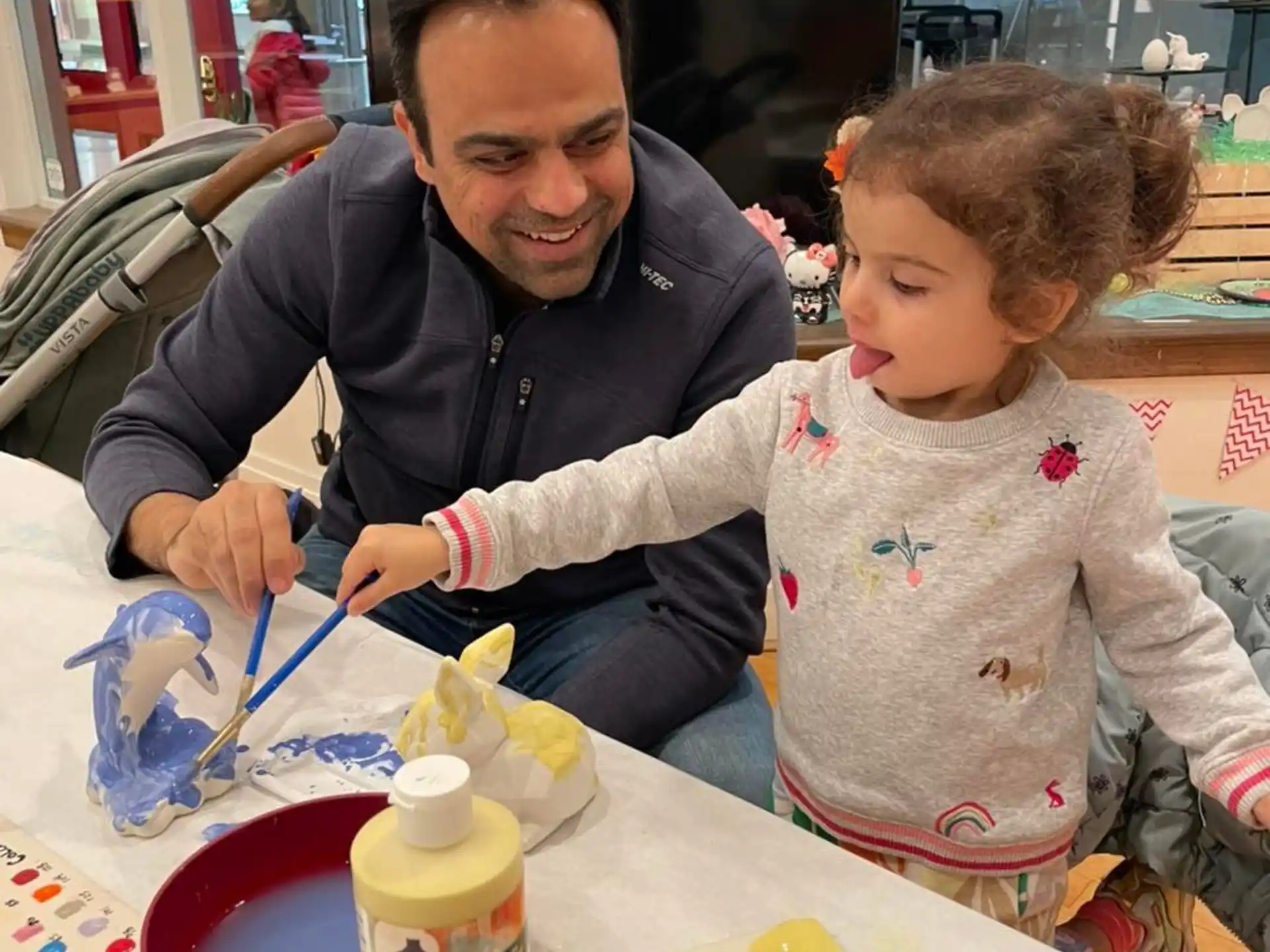 a person and a child painting