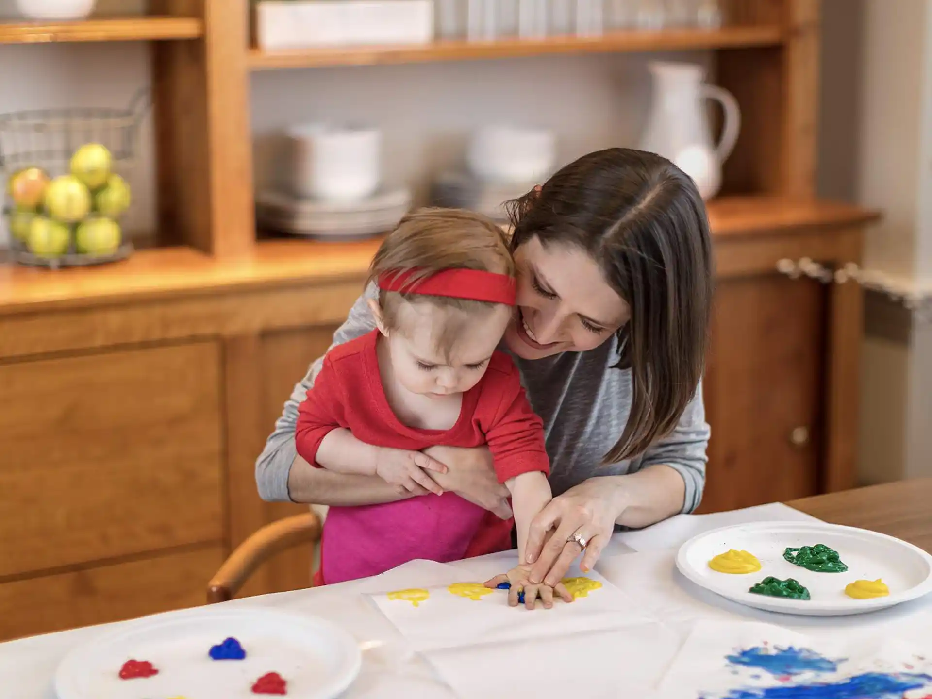 a person and a child painting