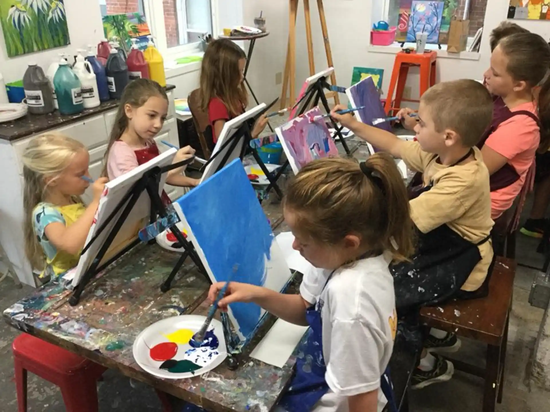 a group of children painting