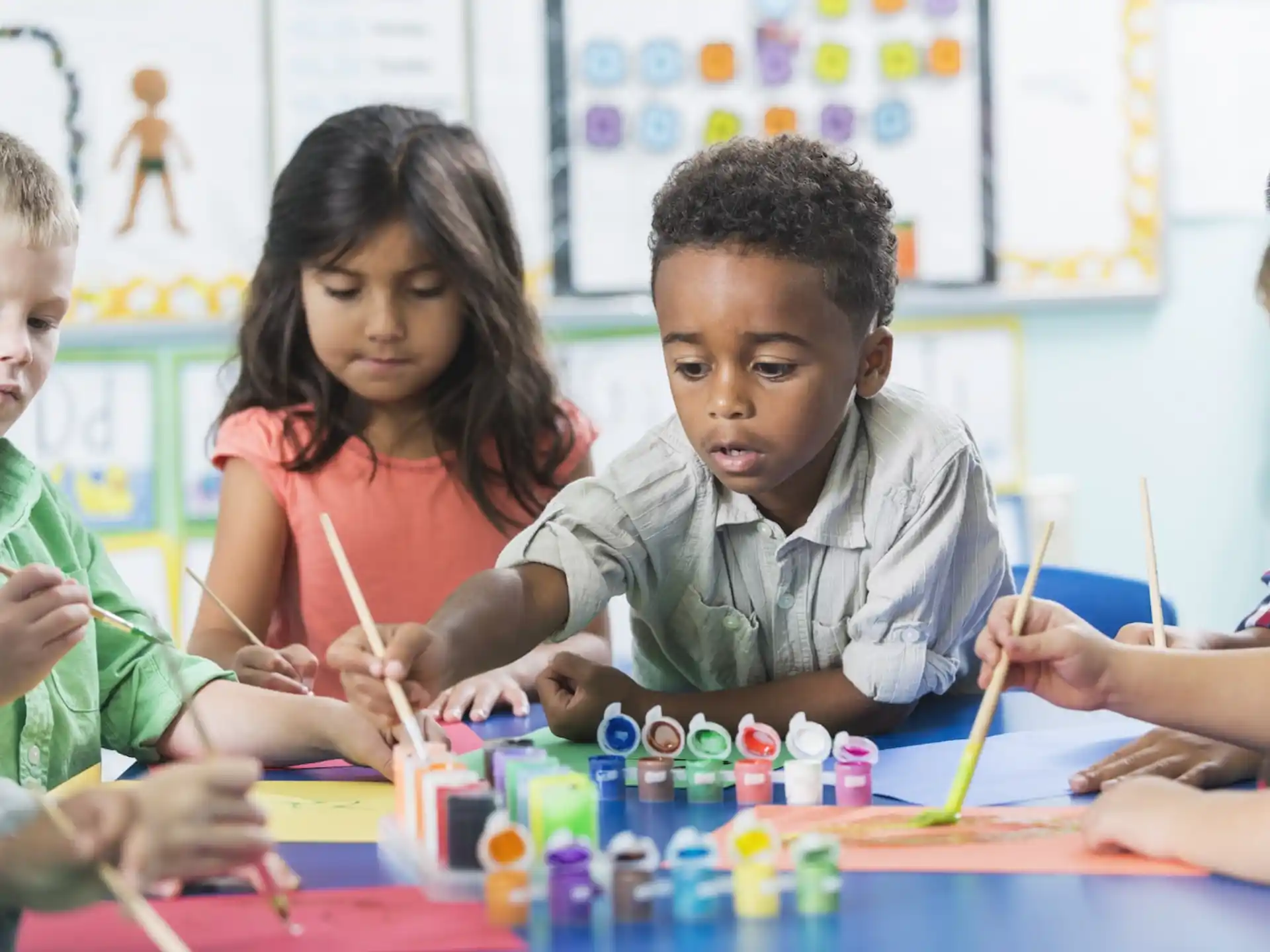 a group of children painting