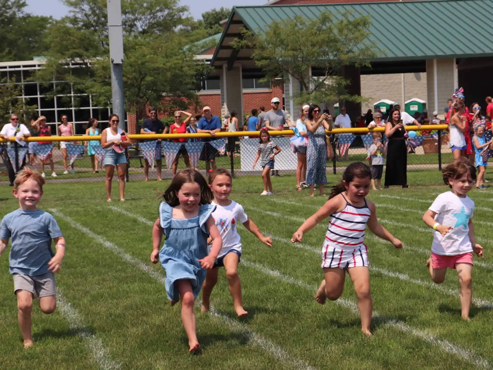 a group of children running on a field
