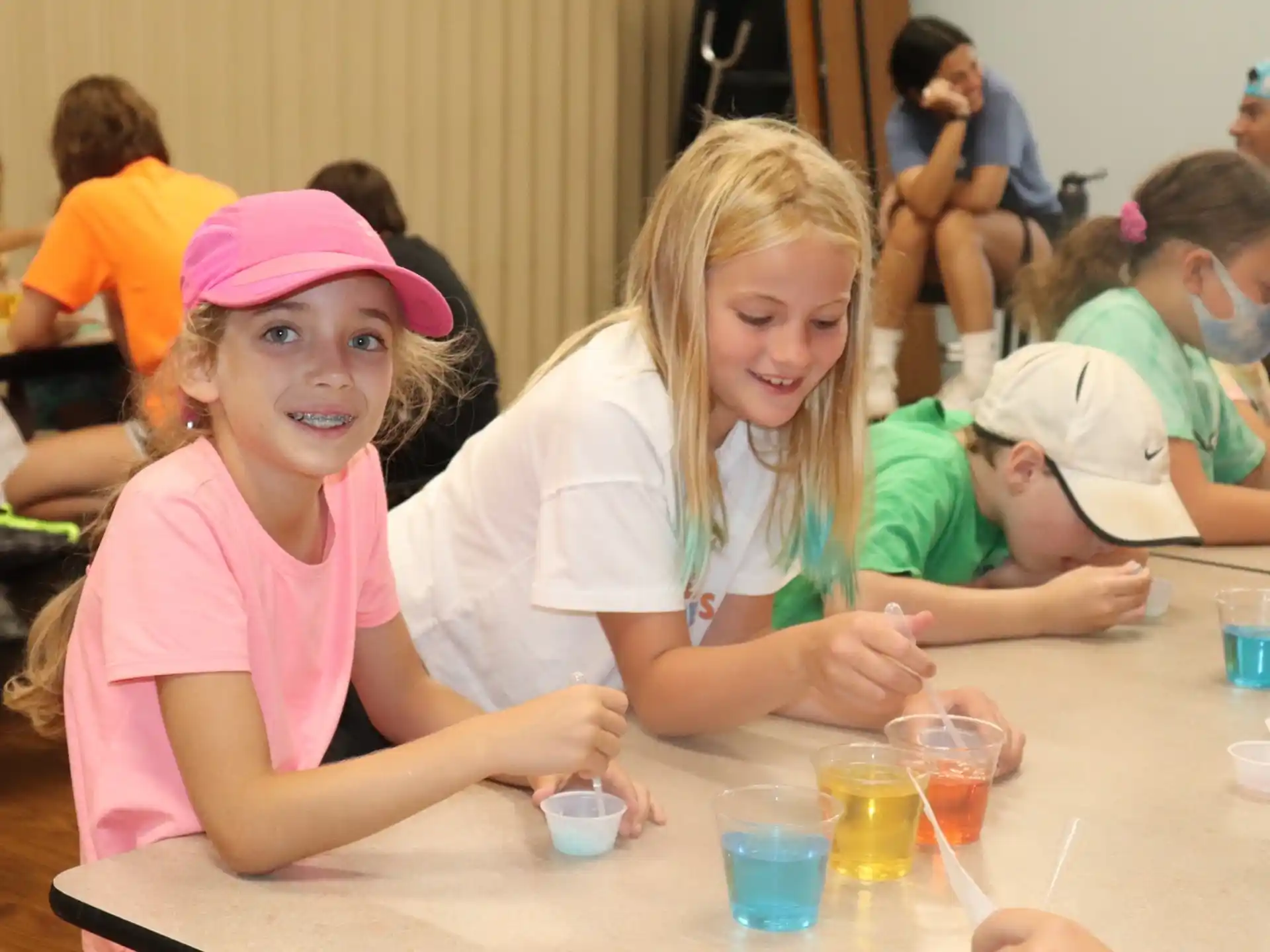 a group of children sitting at a table