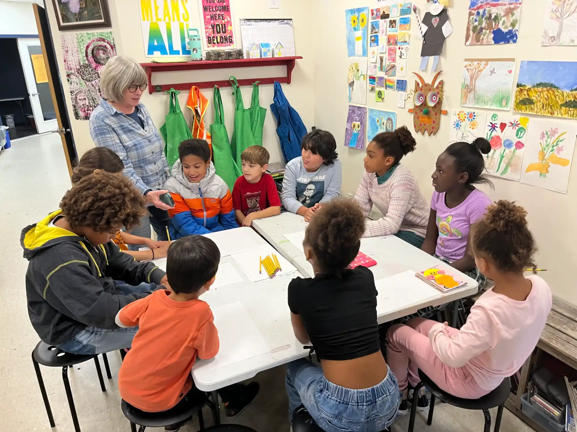 a group of children sitting around a table