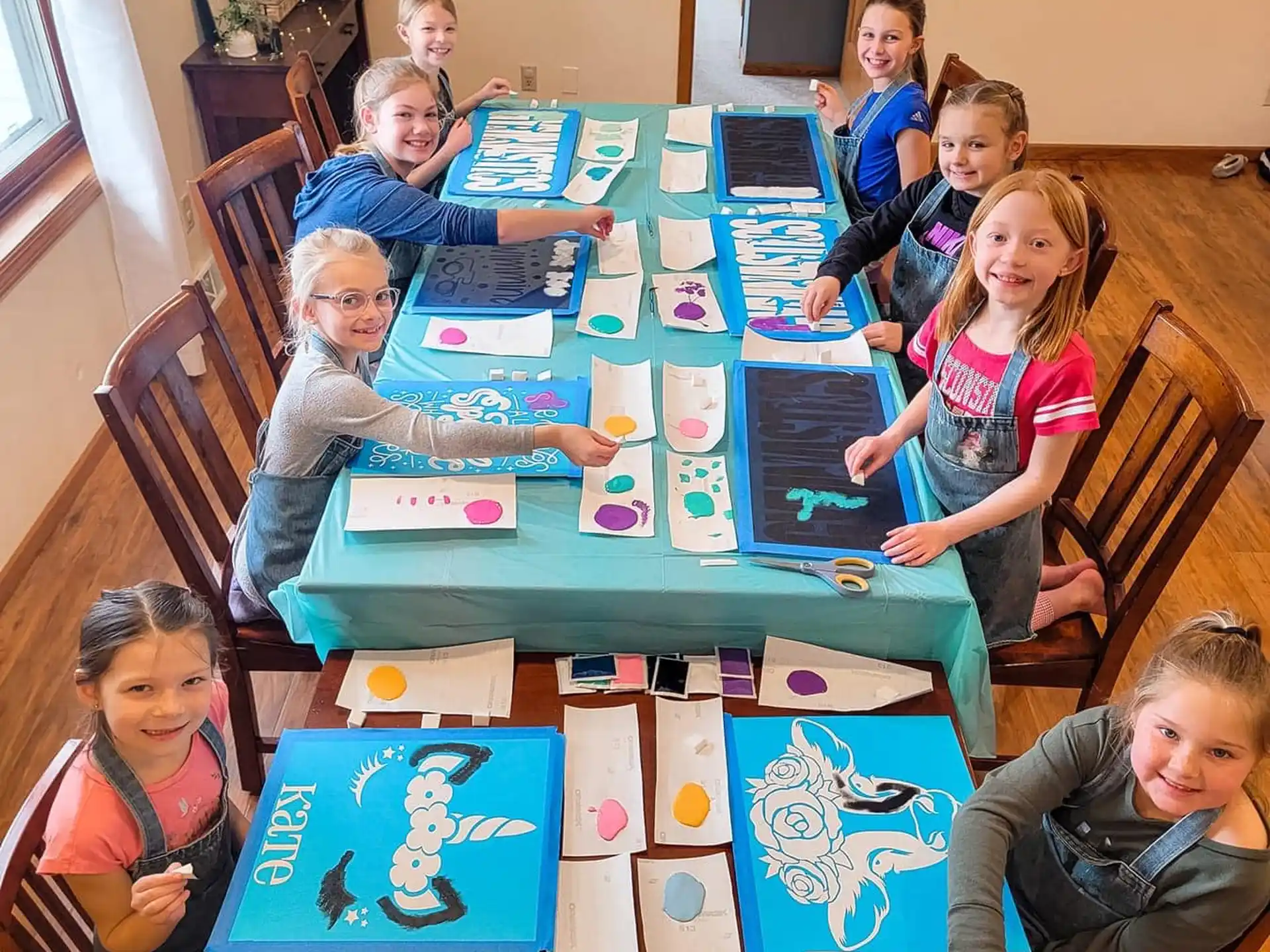 a group of children sitting at a table with books and a book