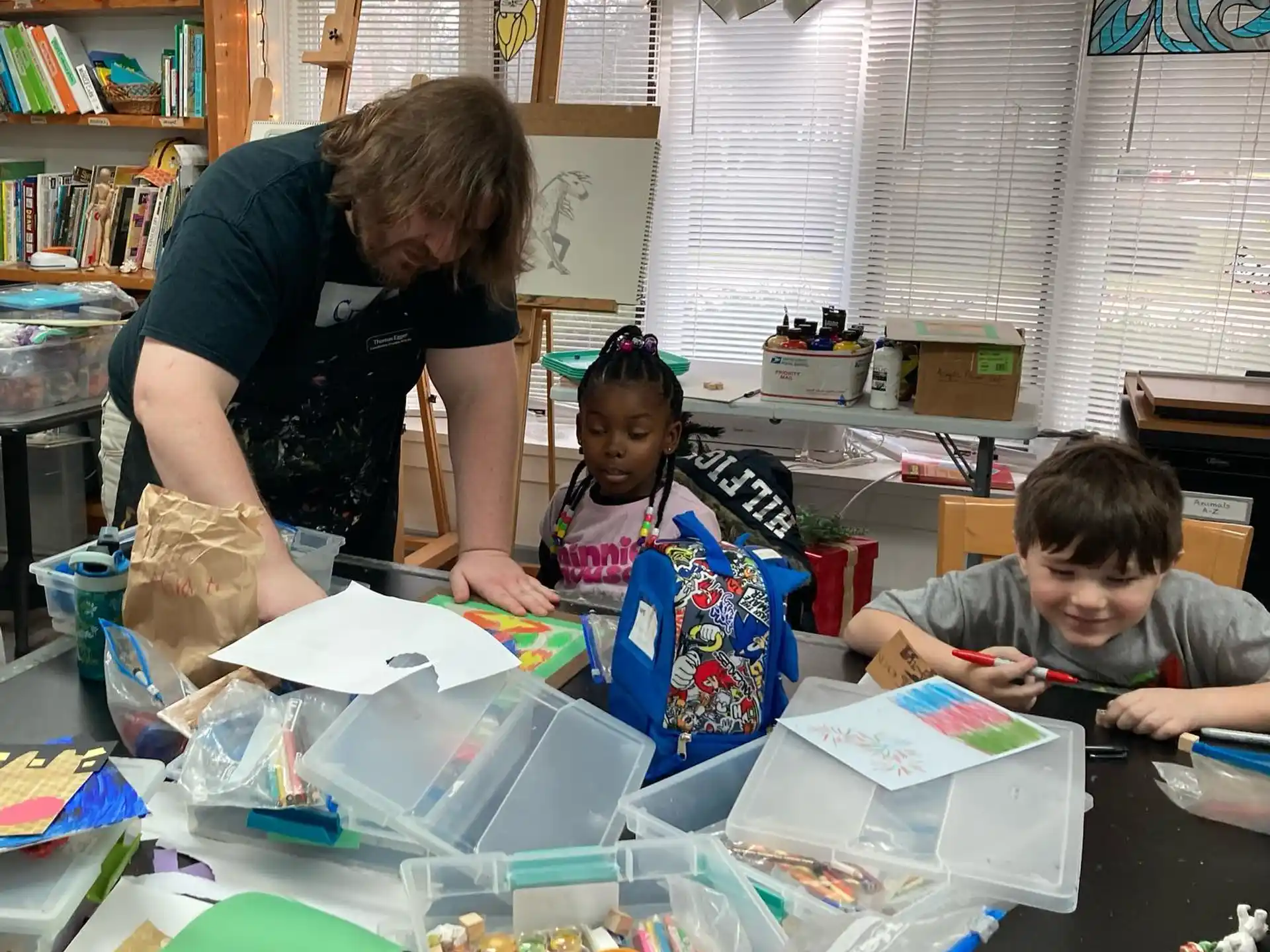 a person and two children working on a project