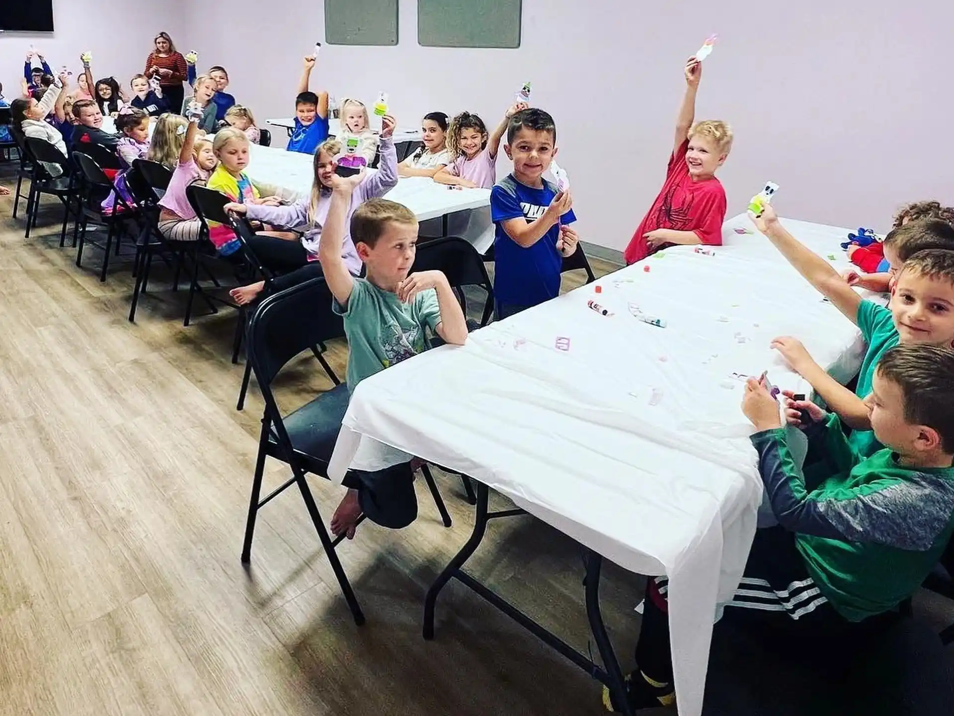 a group of children sitting around a table