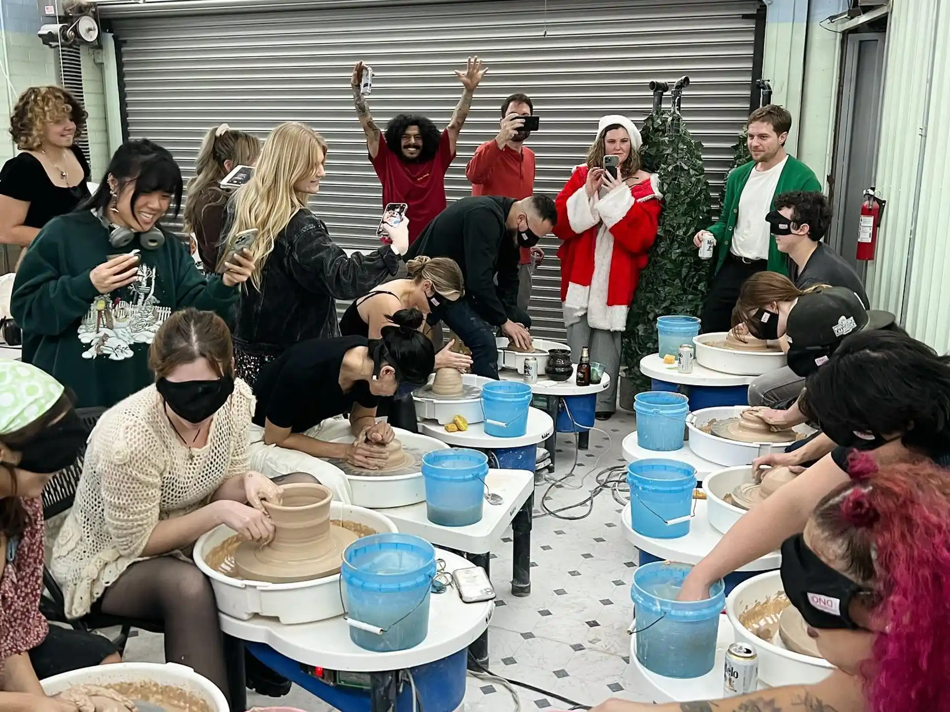 a group of people sitting around a table with food and drinks
