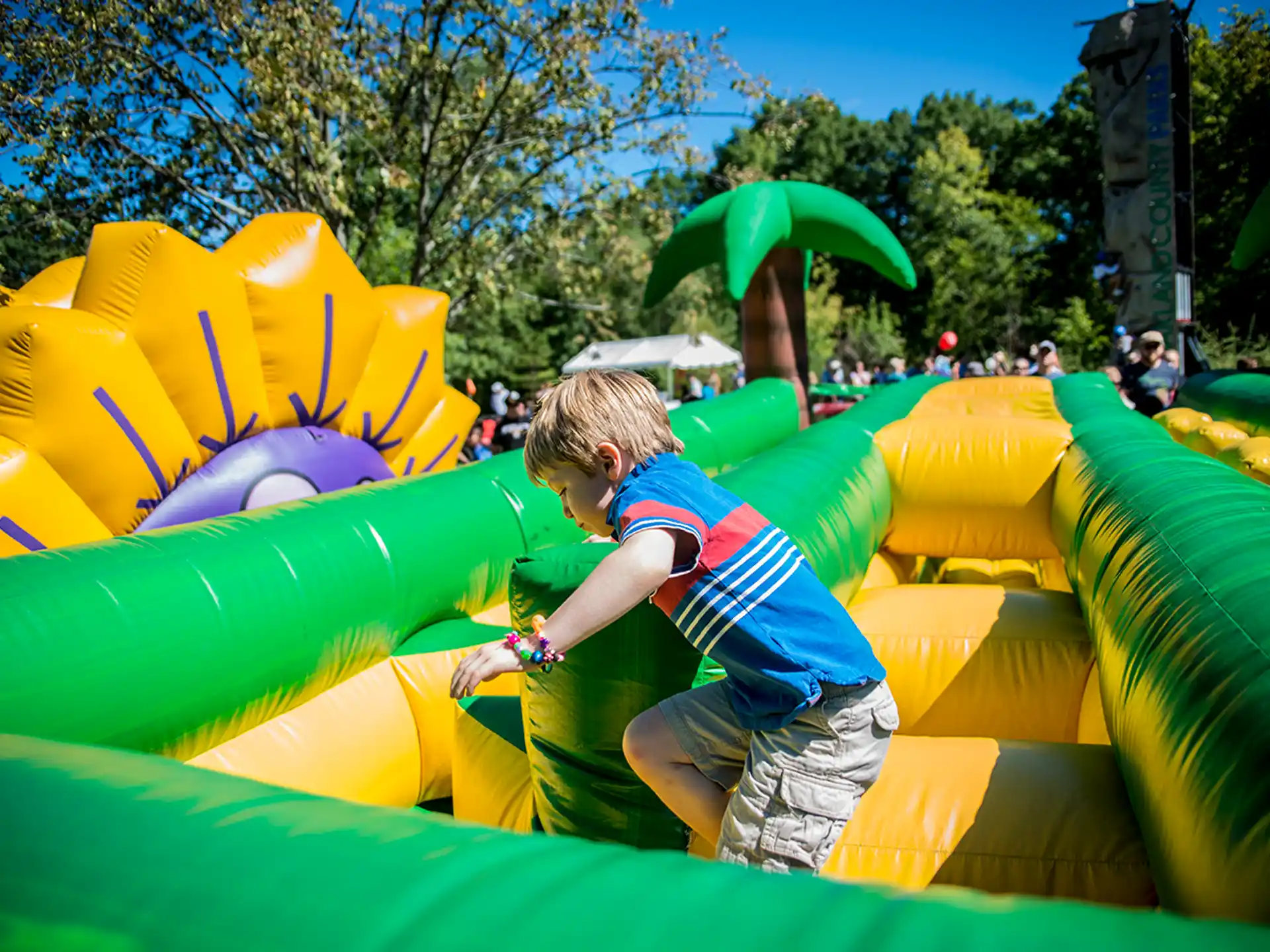 a boy playing in a large colorful playground