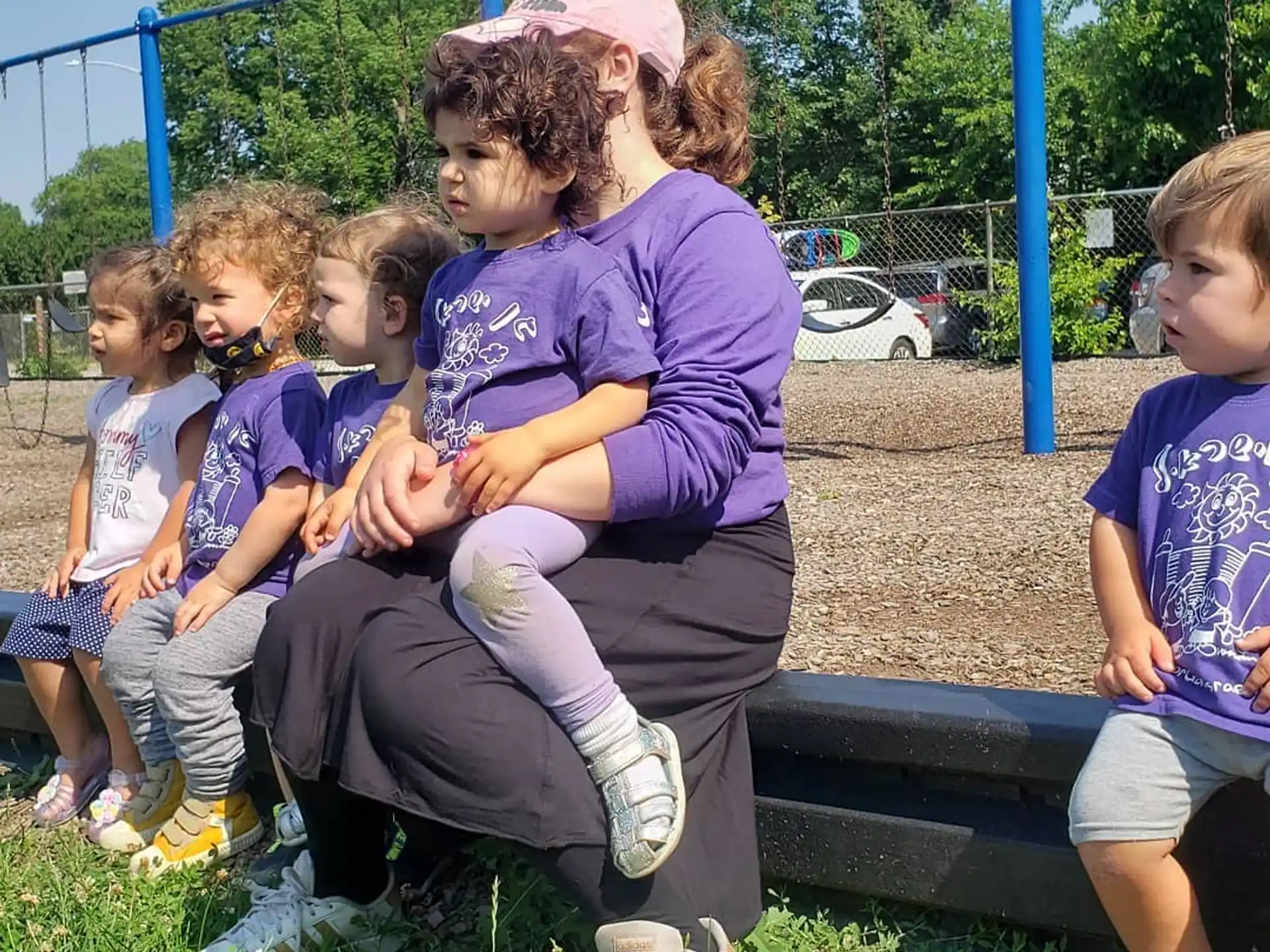 a person sitting on a bench with children