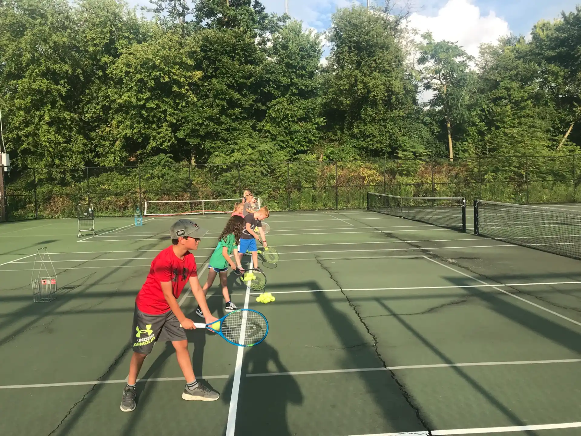 kids playing tennis on a court