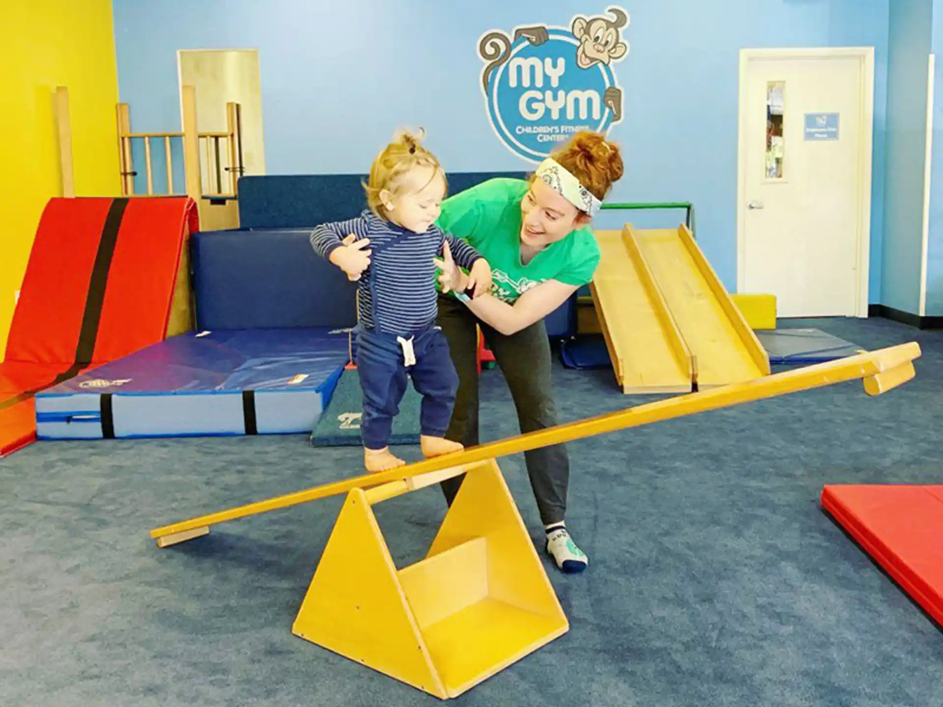 a couple of kids playing on a playground toy