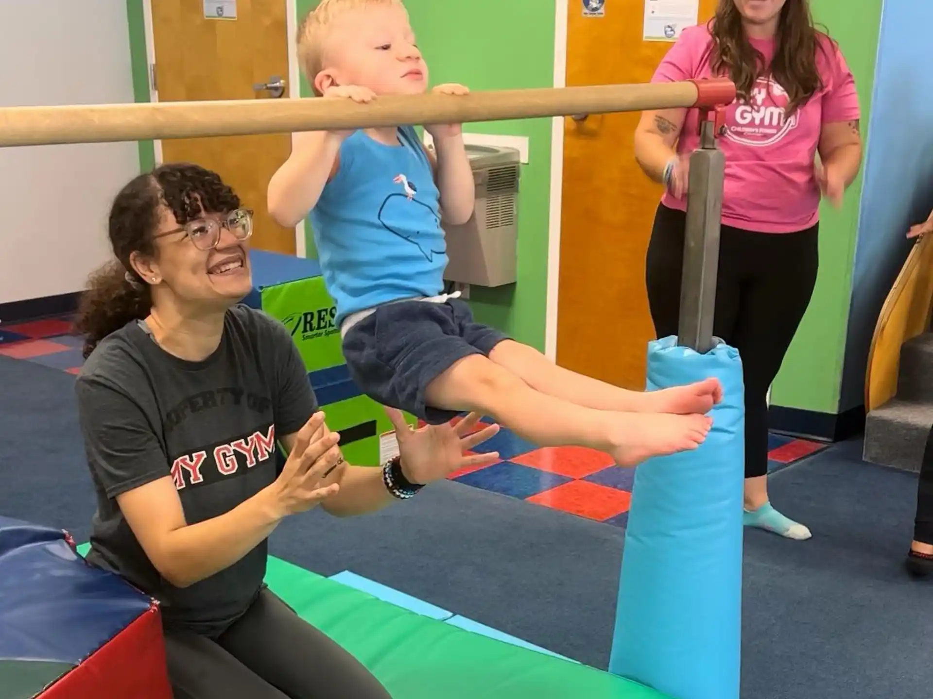 a woman and a child on a mat