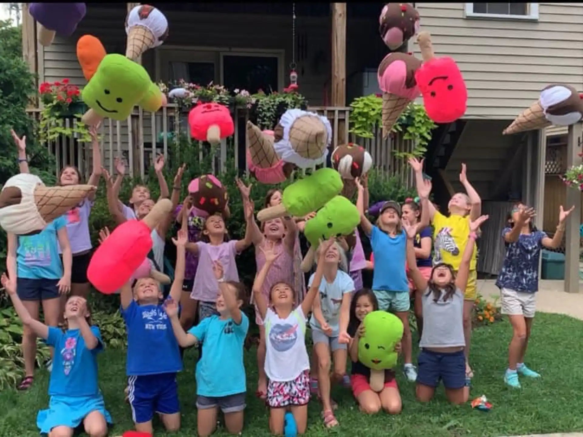 a group of children holding balloons