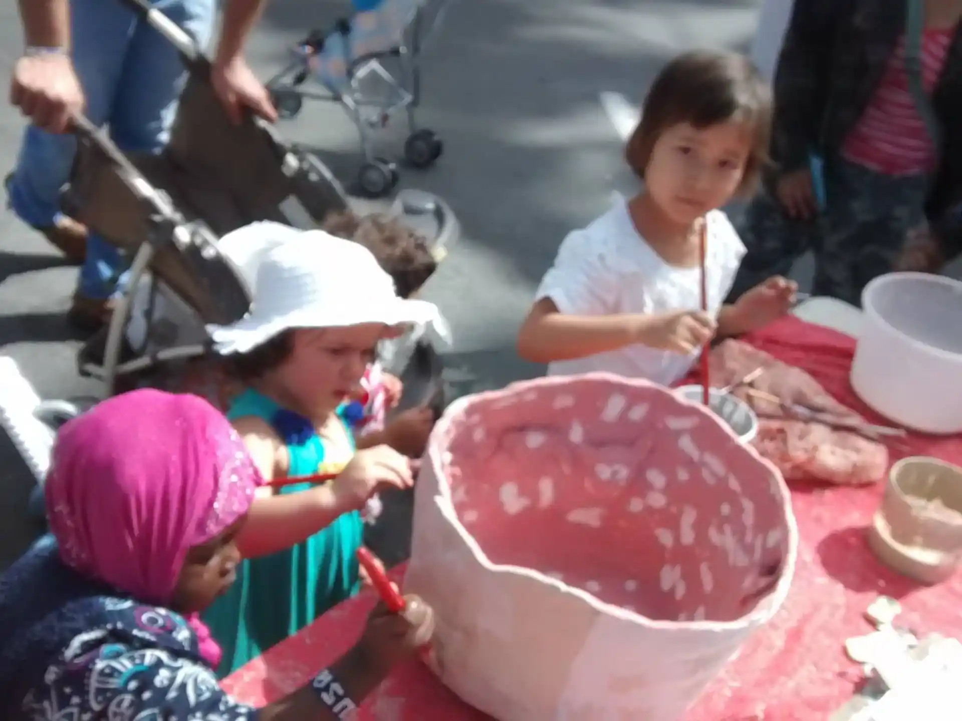 a group of children sitting at a table with food