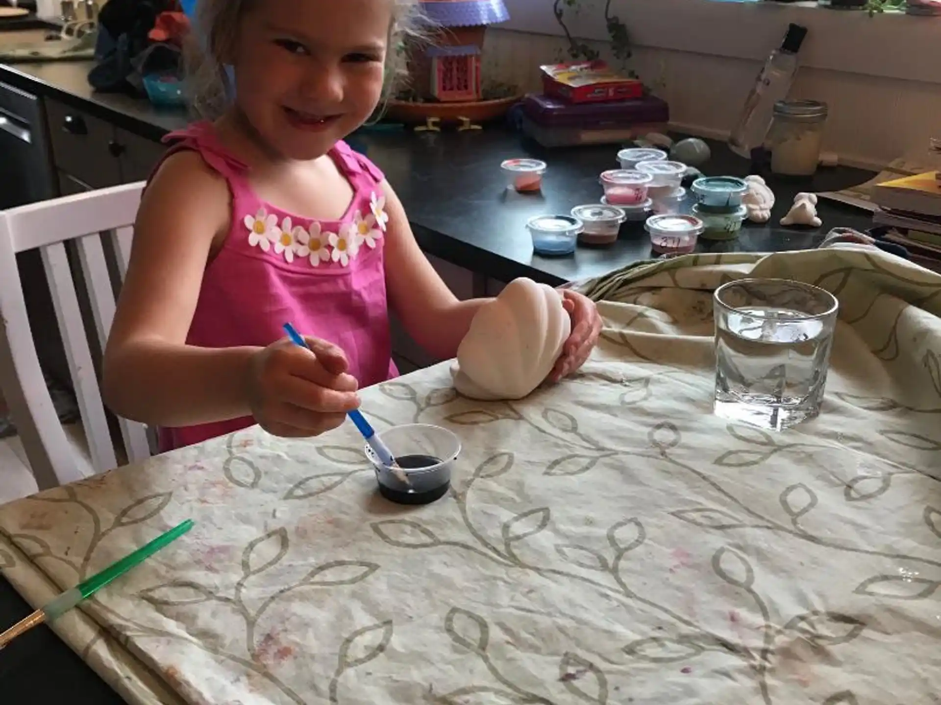a girl painting on a table