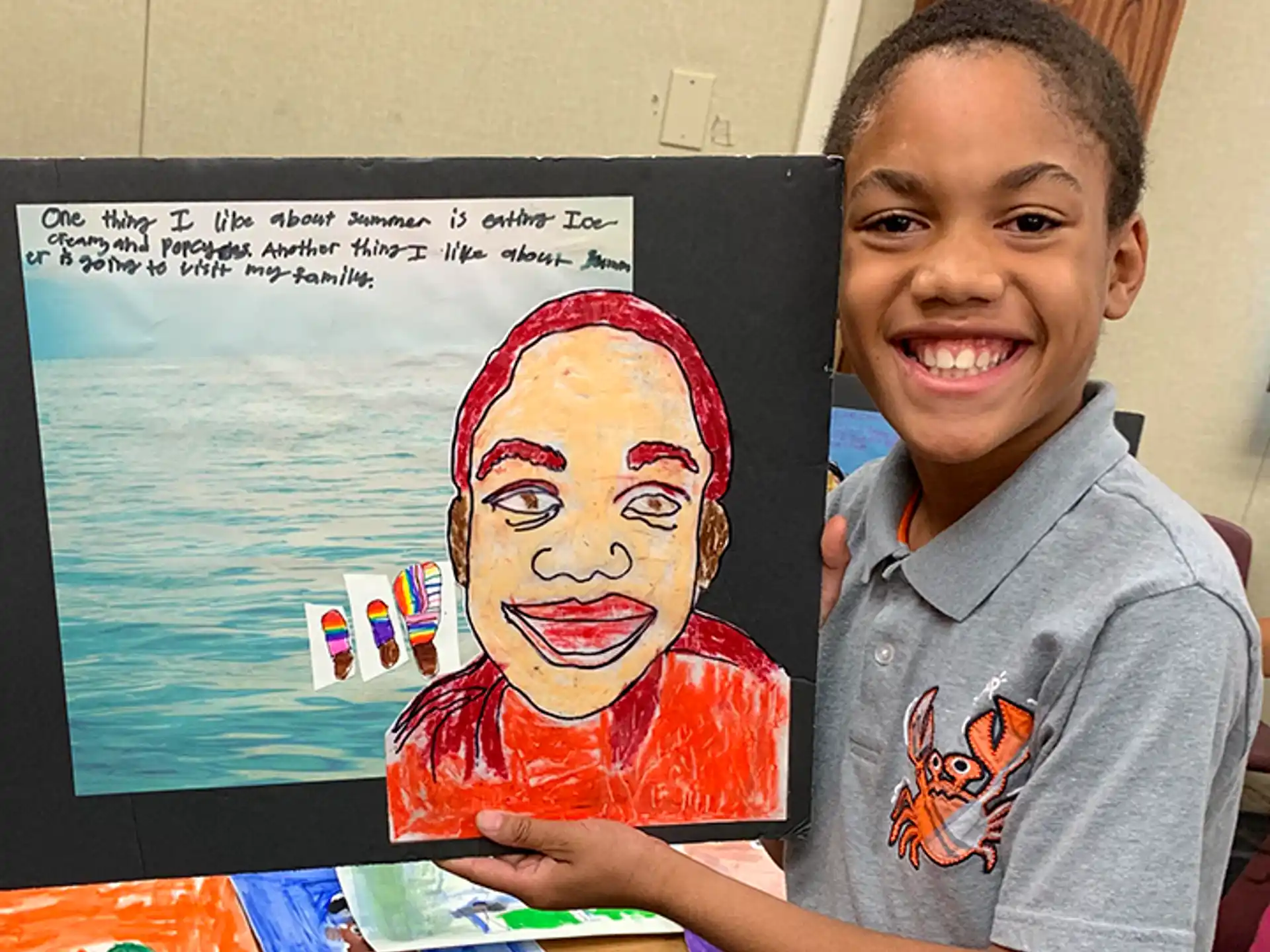 a boy holding a drawing