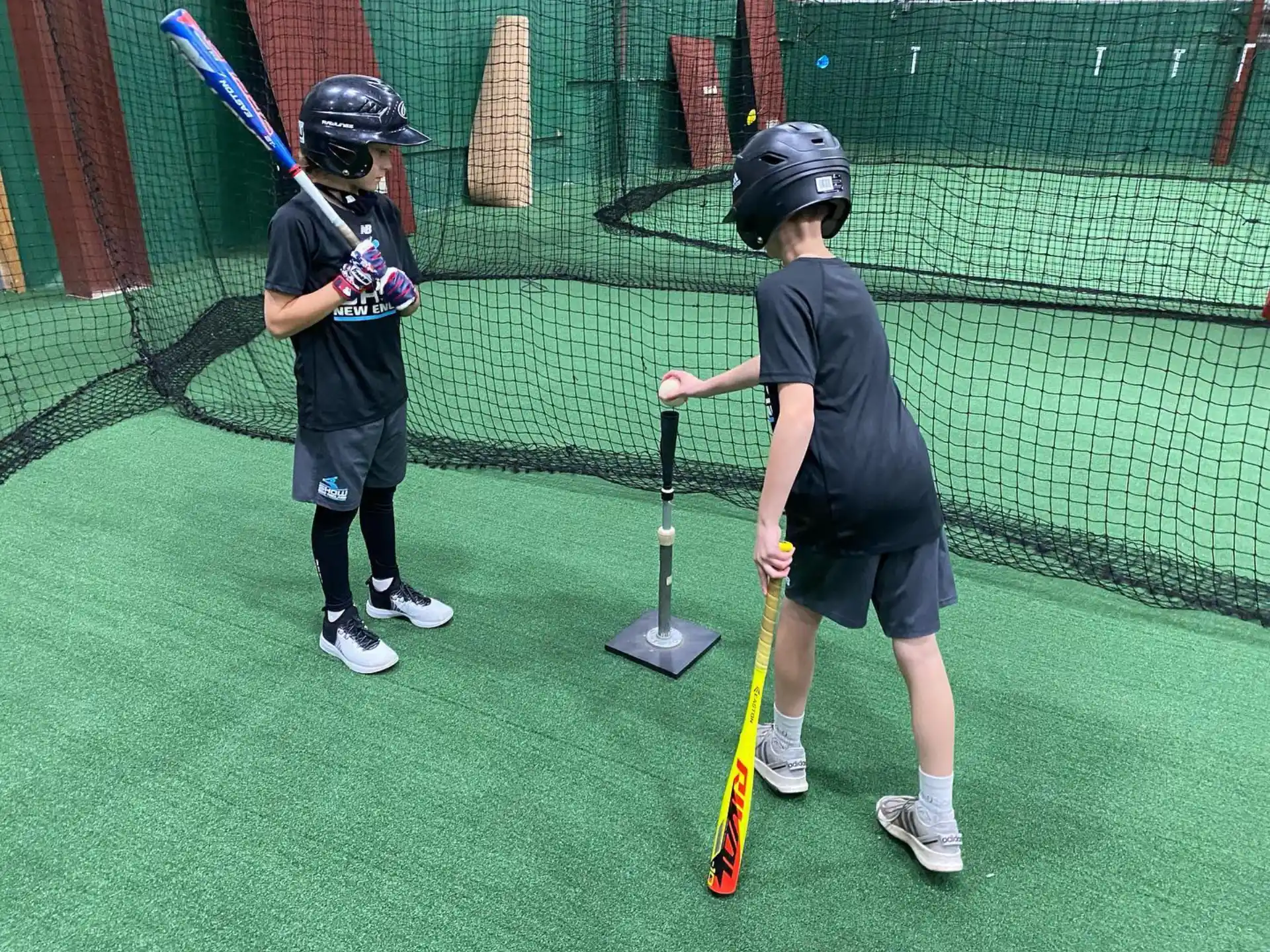 kids holding bats on a field