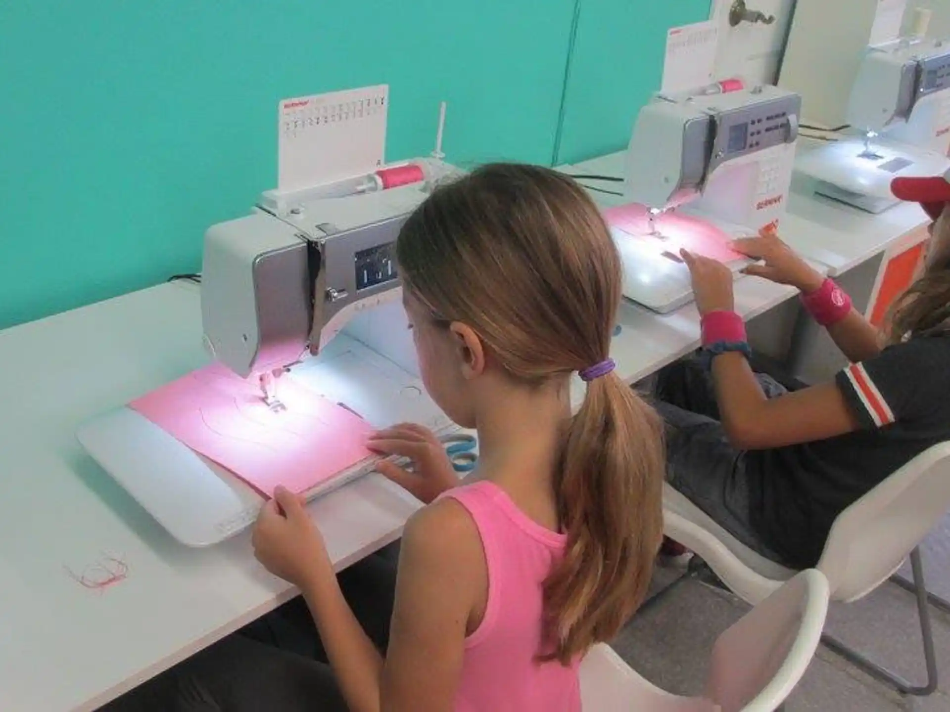 a few young girls working on a project