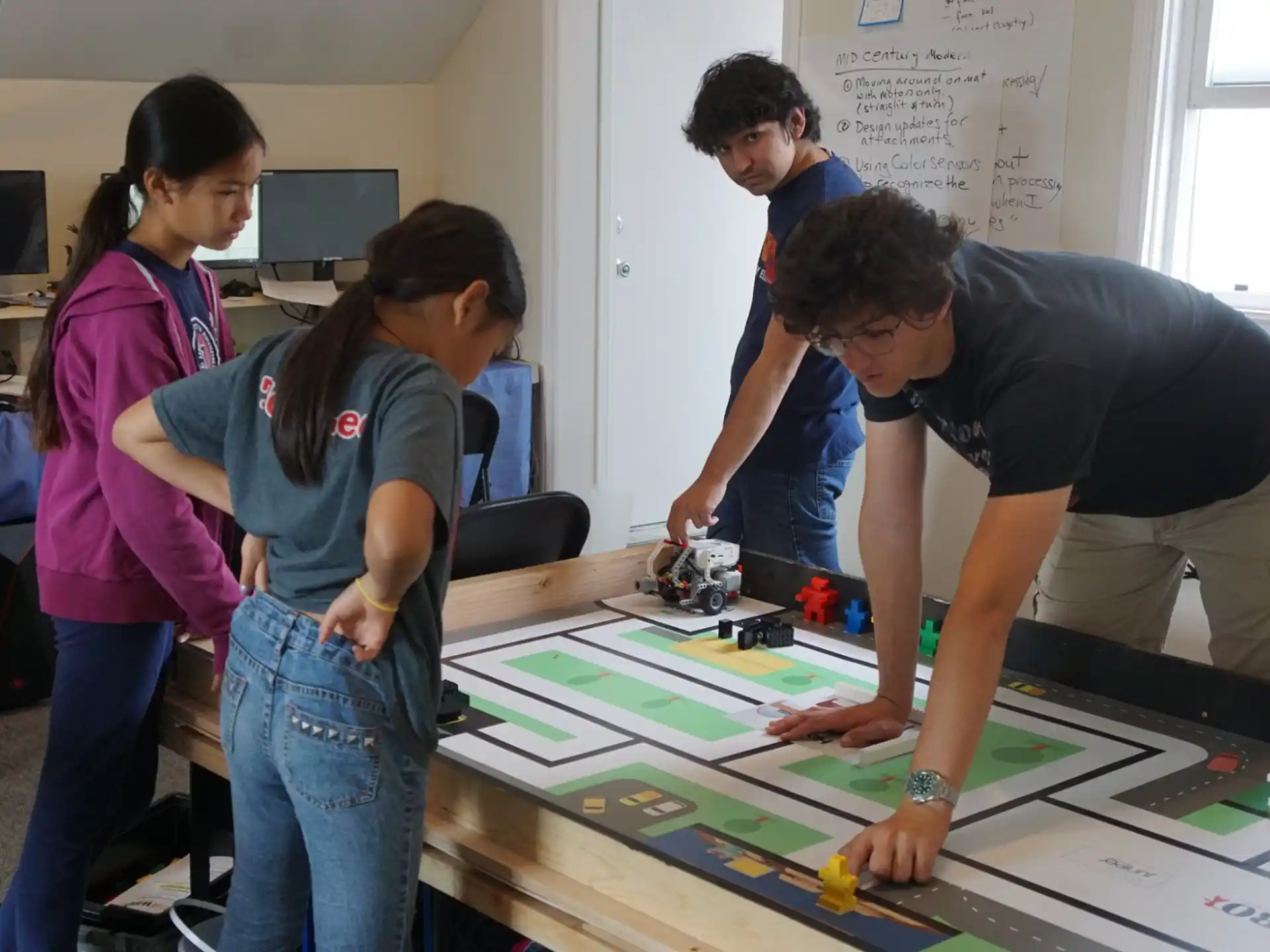 a group of people looking at a map on a table