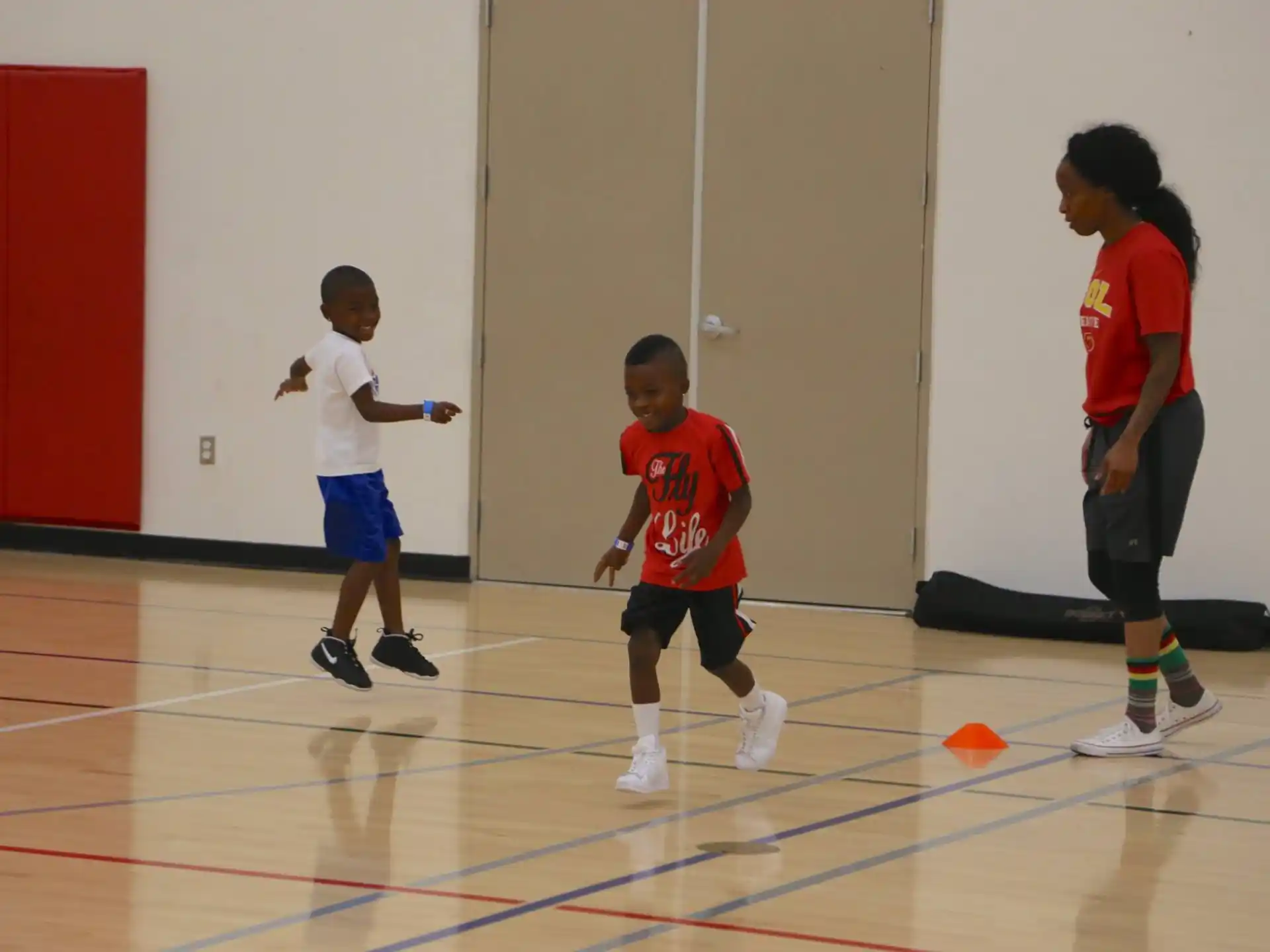 a group of kids playing basketball
