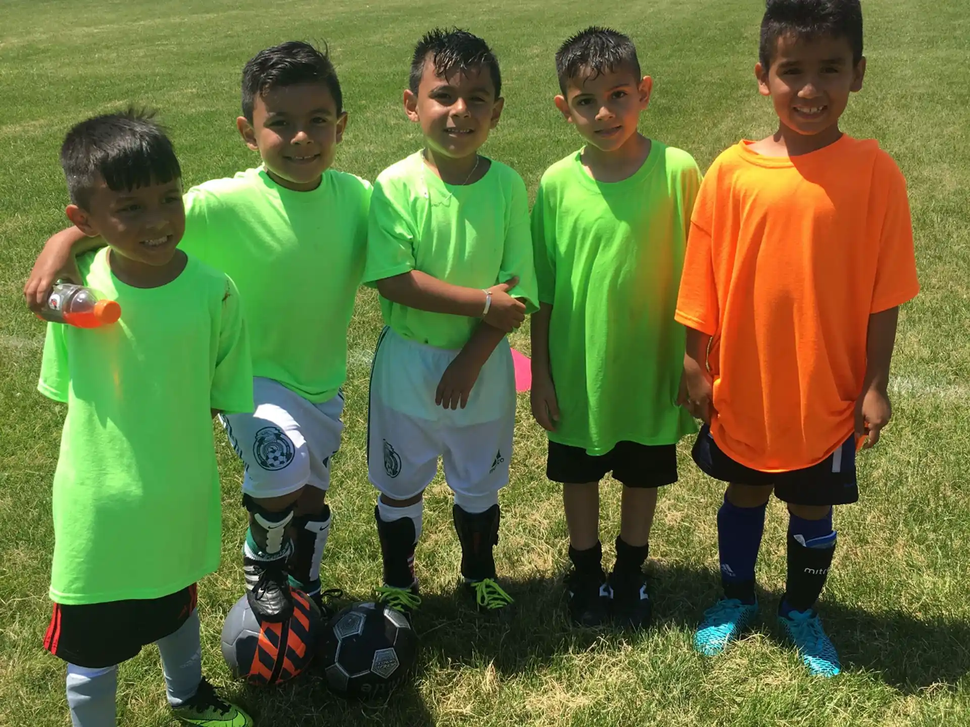 a group of boys in green shirts