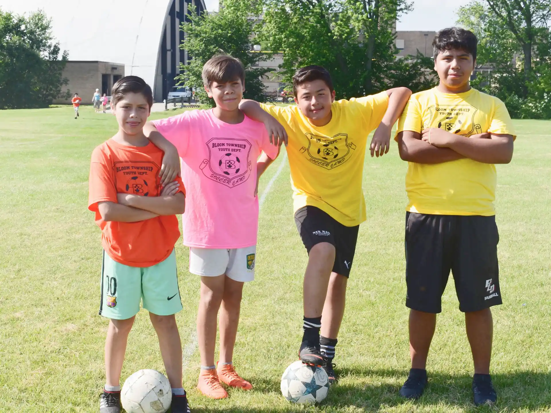 a group of boys posing for a picture with a football ball