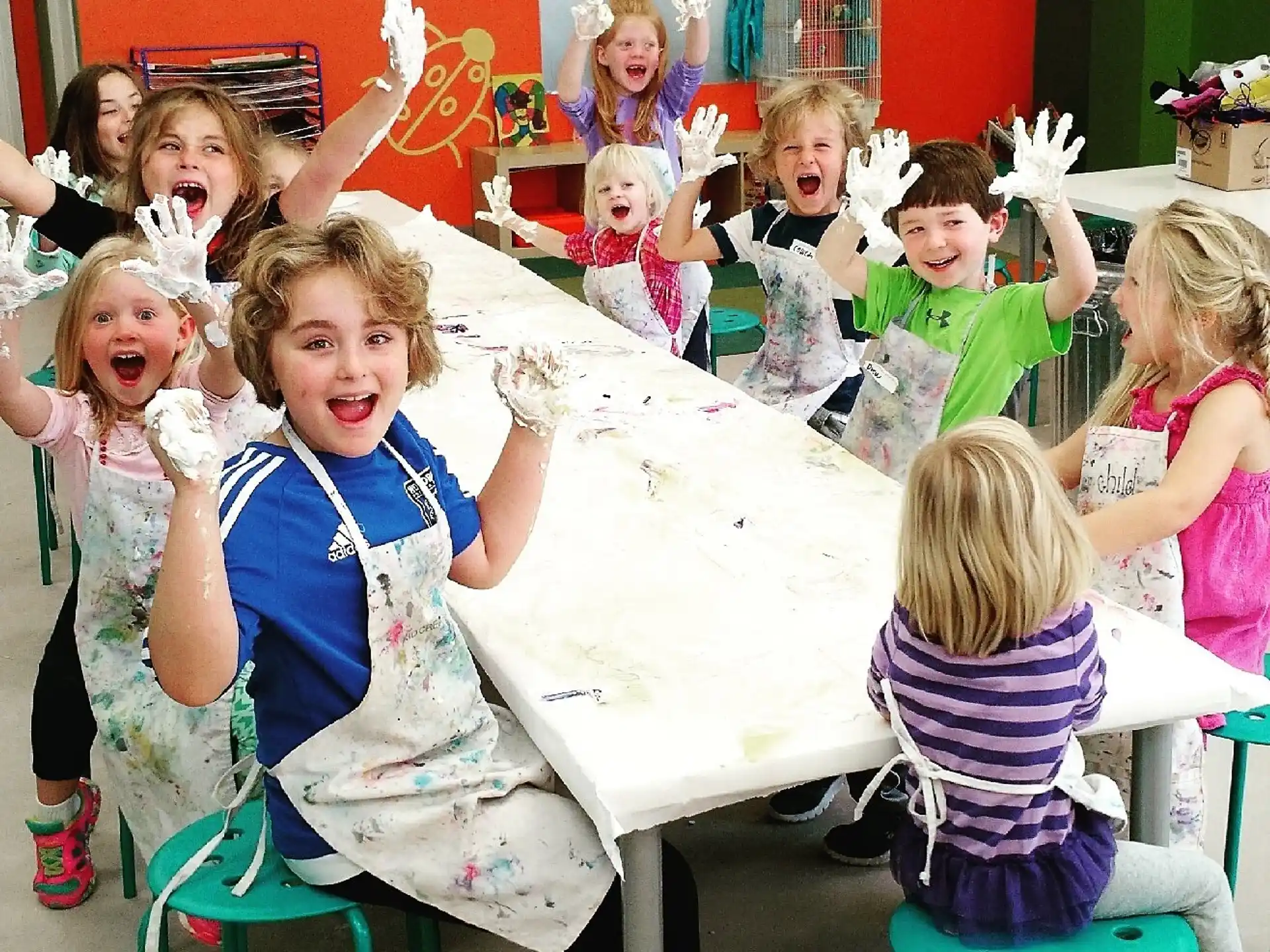 a group of children sitting at a table with toys