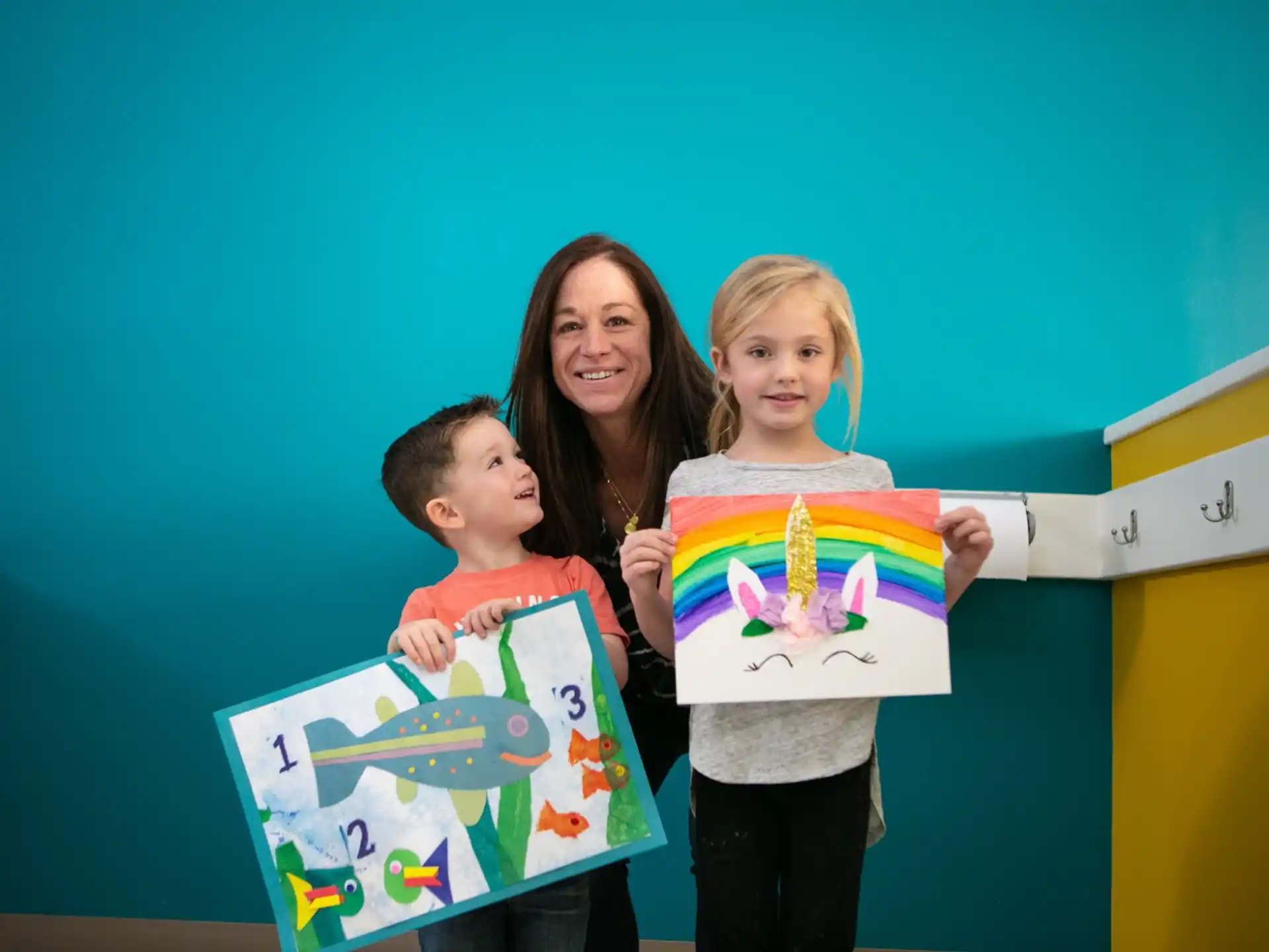 a person and two children holding signs