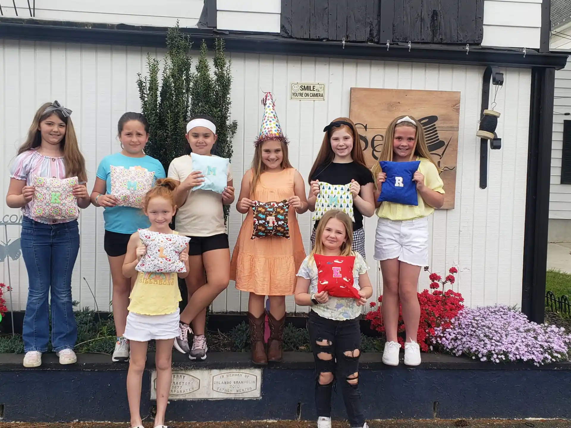 a group of people posing for a photo in front of a house