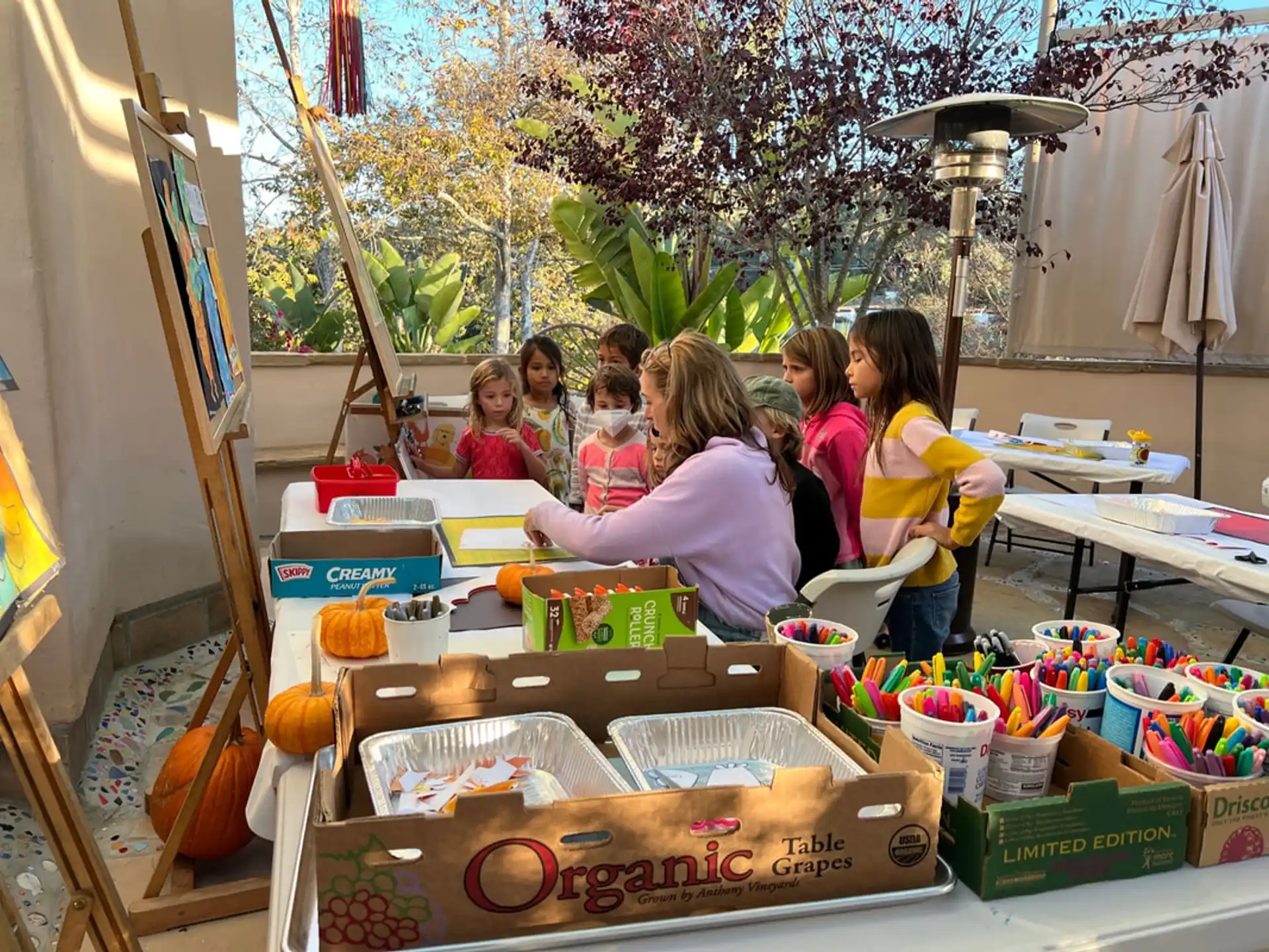 a group of people sitting at a table with food