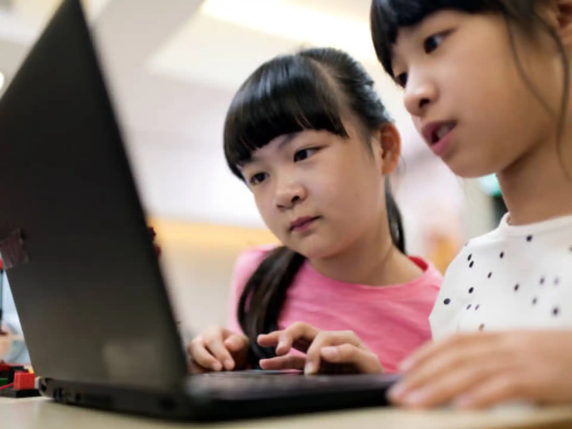 a person and a child looking at a computer screen