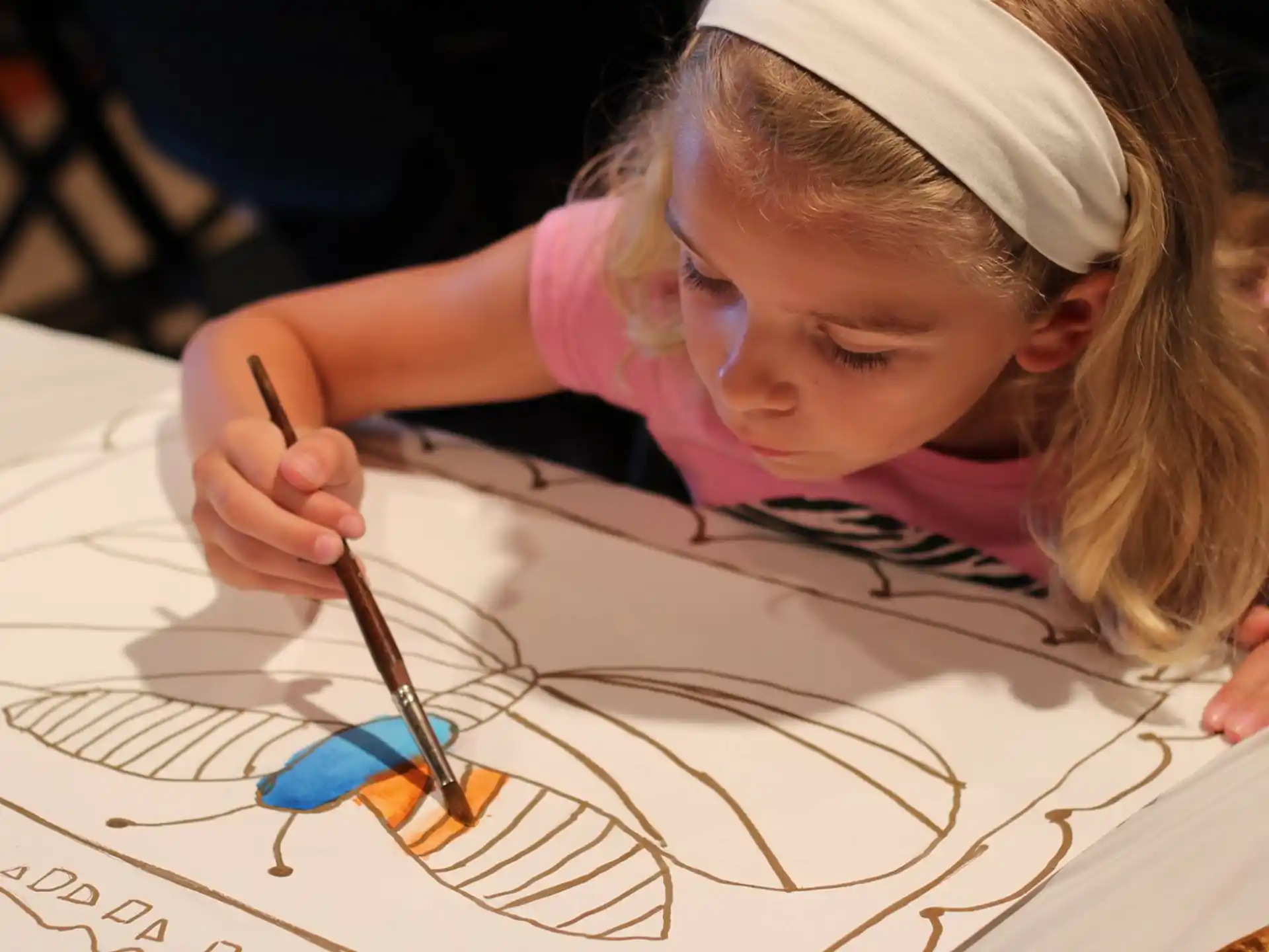 a young girl drawing on a paper