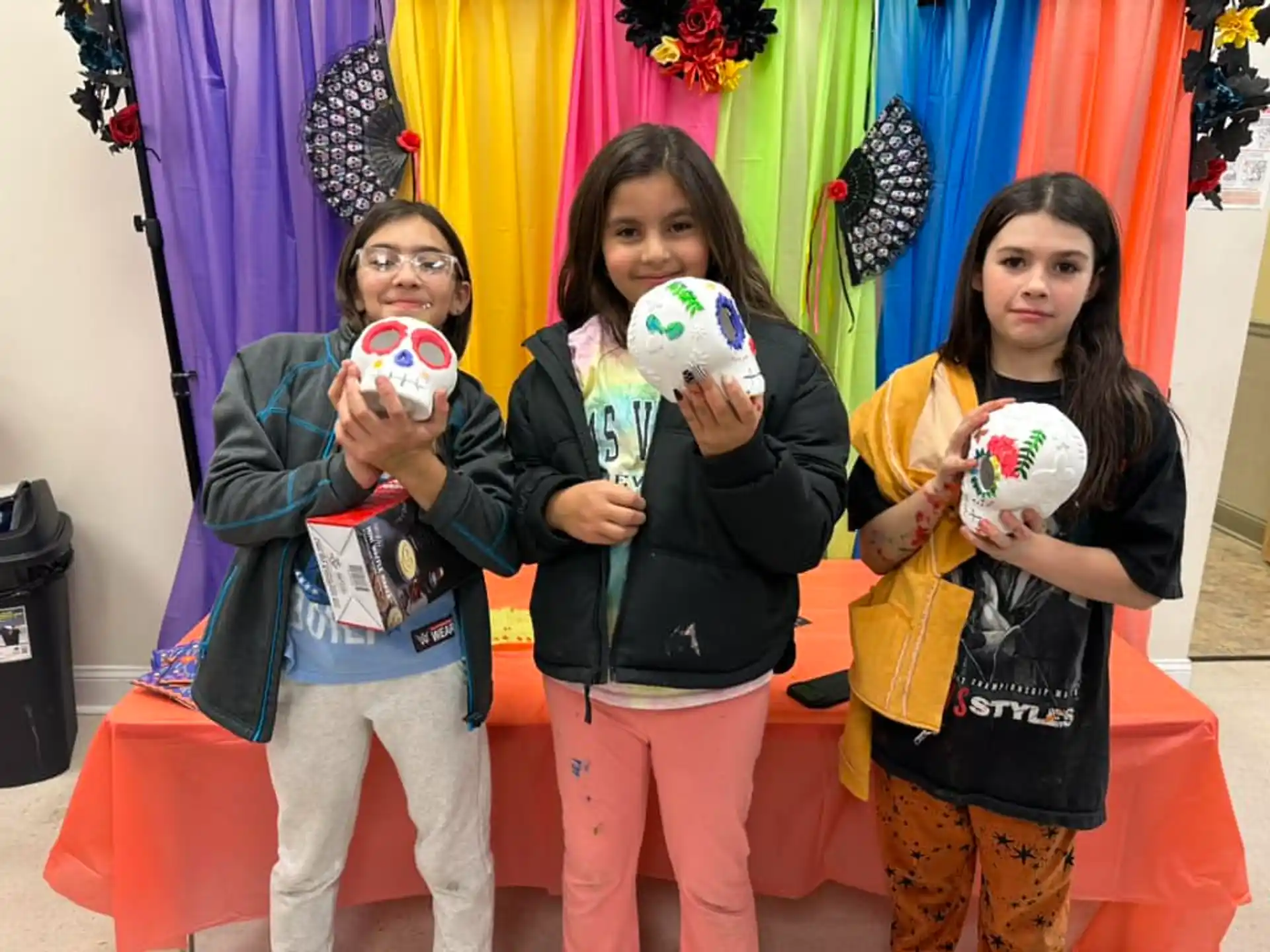 a group of girls holding objects posing for the camera