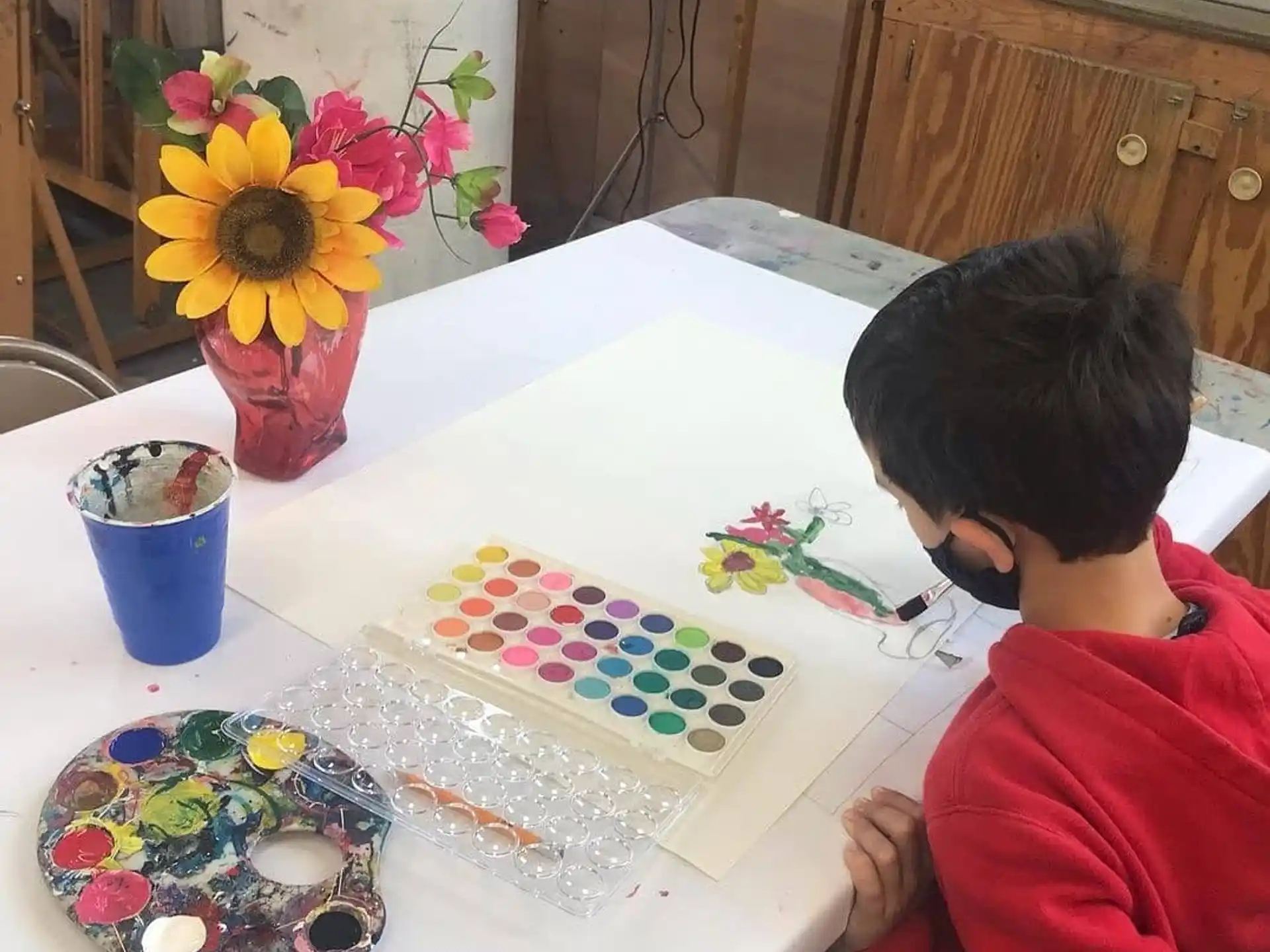 a child painting on a table