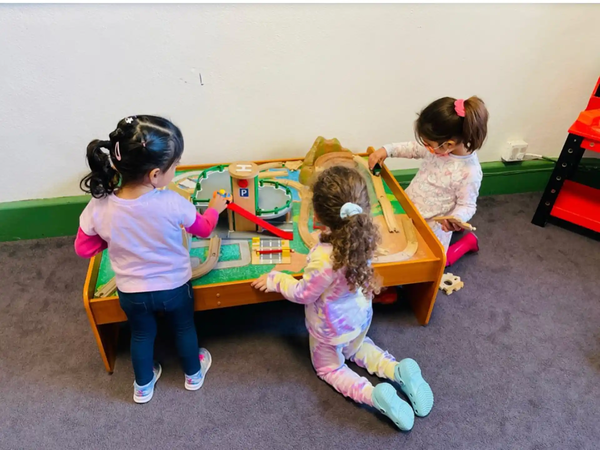 a group of children playing on a playground toy