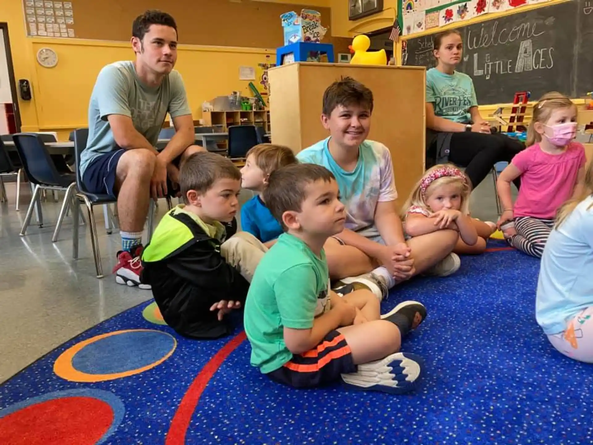 a group of children sitting on the floor