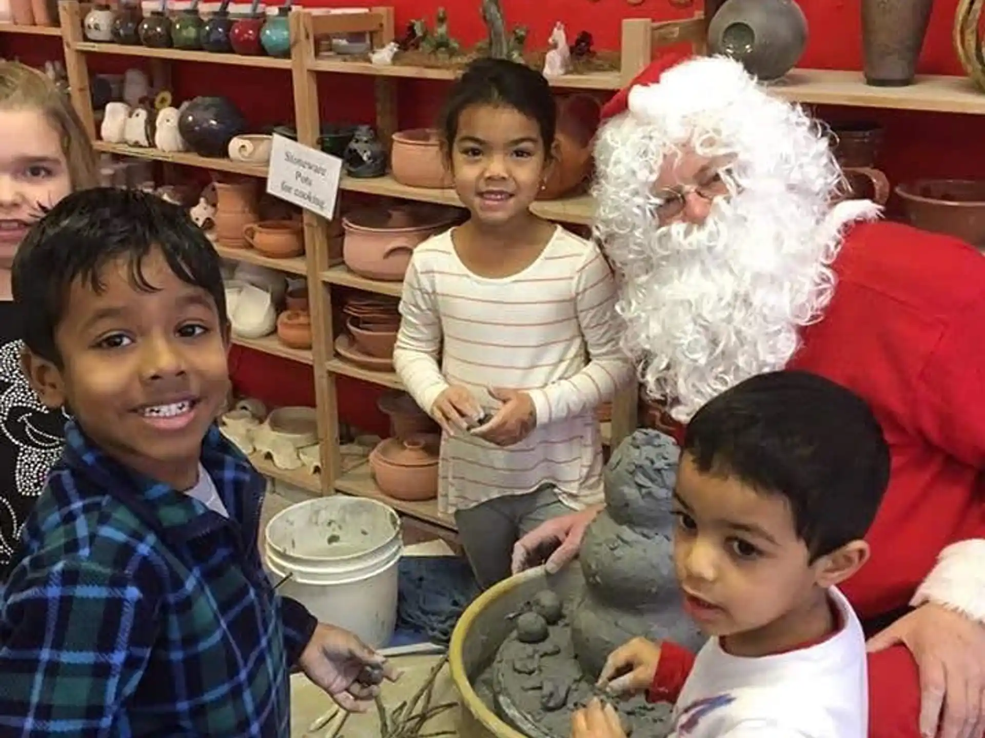 a group of children posing for a photo with a santa claus