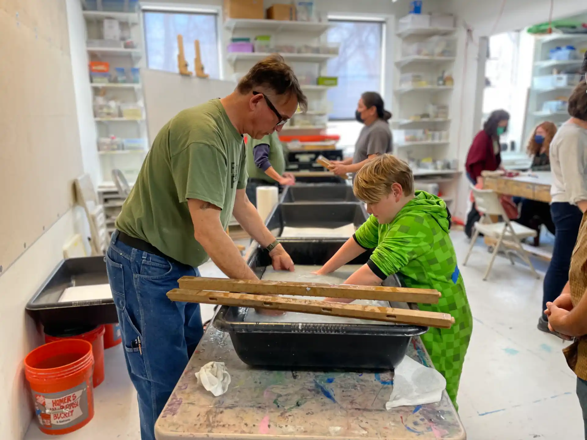 a person and a boy cooking