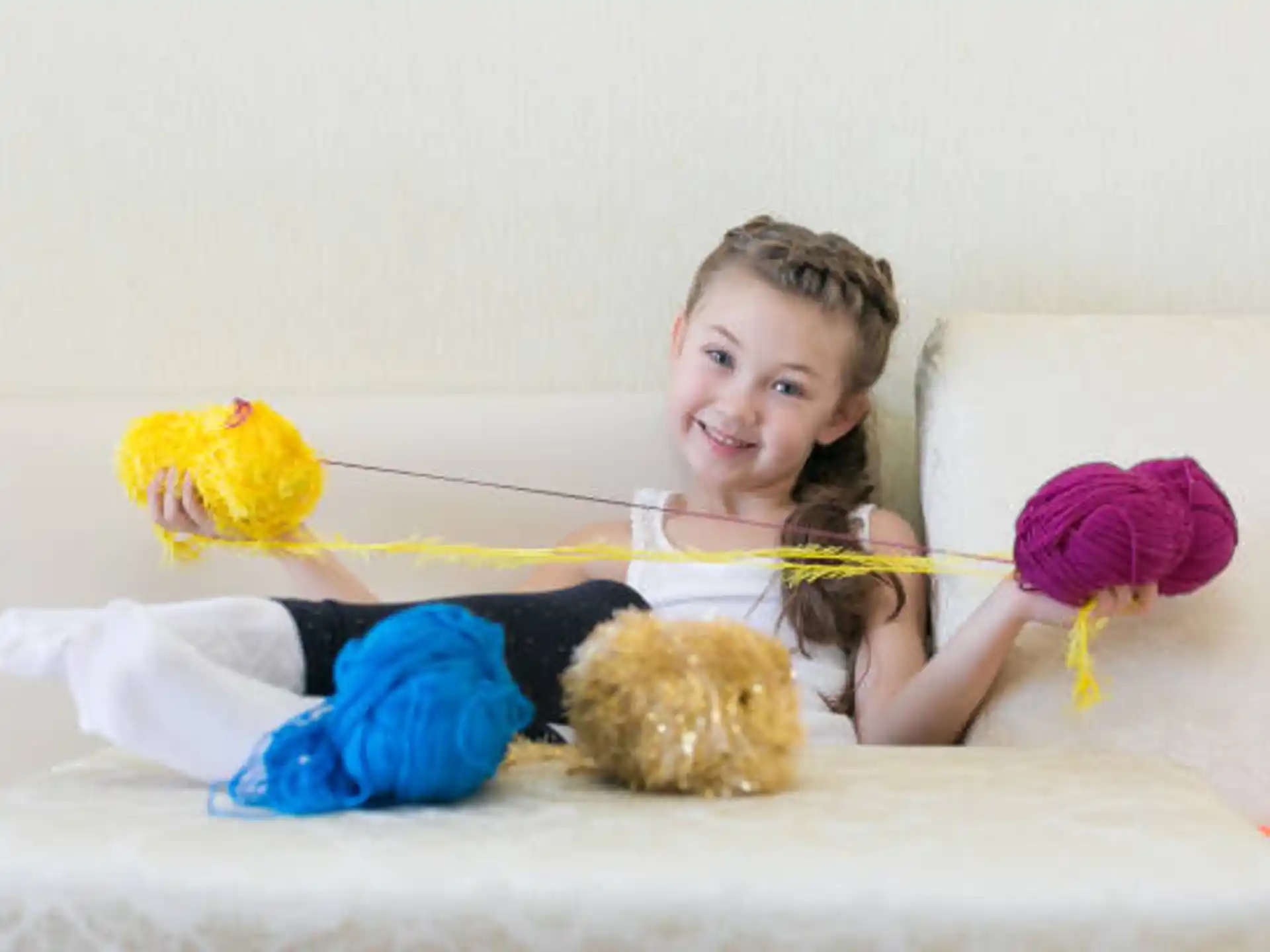 a girl lying on a bed with stuffed animals