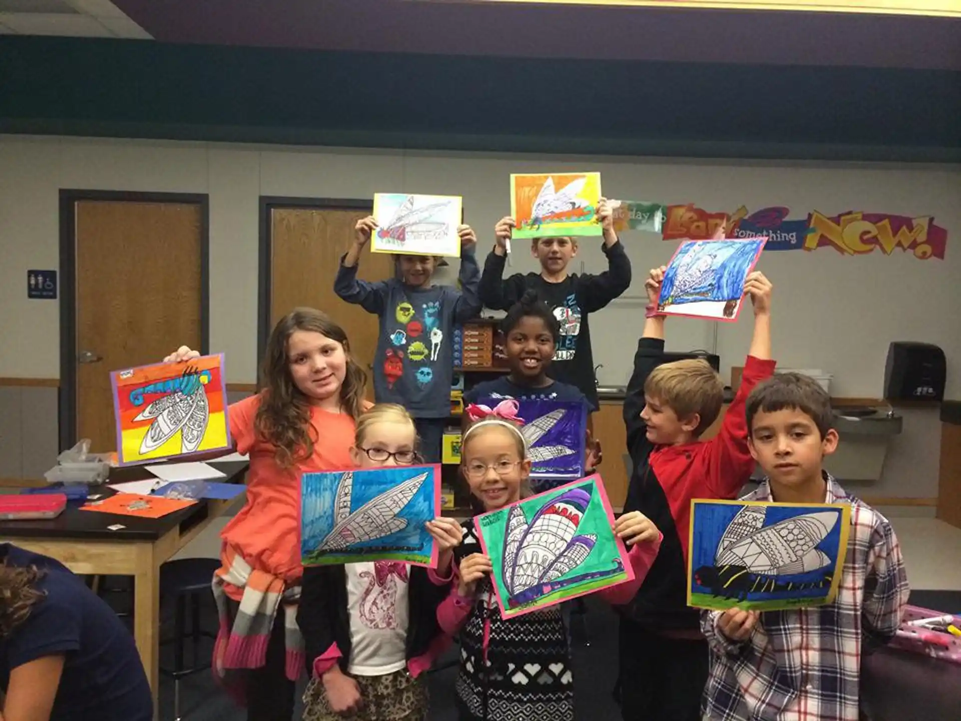 a group of children holding up books