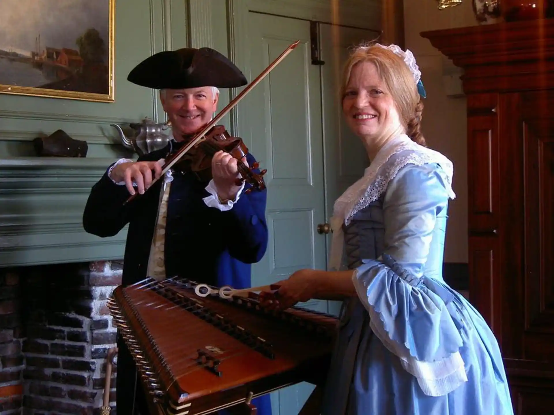 a man and woman playing a violin