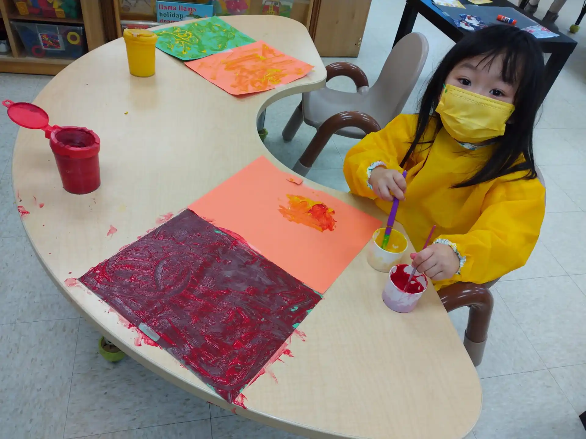 a girl painting on a table