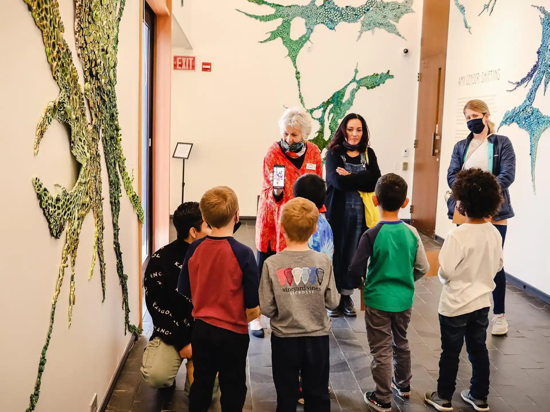 a group of people looking at a painting